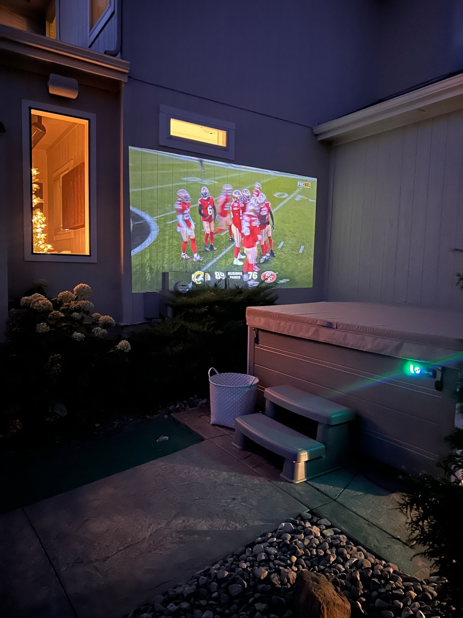 Because why wouldn’t we project a tv screen onto the house?!