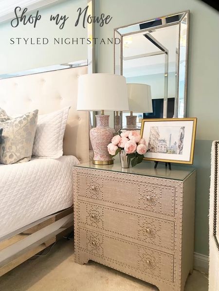 Styled nightstand with chinoiserie pink lamp gold framed Paris print from Etsy and my favorite faux peonies from Pottery Barn 

Nailhead nightstand 
Master bedroom primary bedroom mirror framed mirror
Bed pillows 
White quilt #decorating #designing #styletip #interiordesign 

#LTKstyletip #LTKhome #LTKsalealert