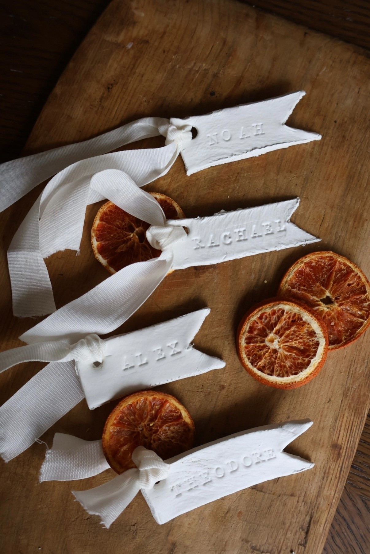 Air dry clay holiday name tags! These are so easy to make and look adorable— all you do is roll out some air dry clay, use your letter stamps to stamp the persons name, and then cut into whatever shape you want. Then I made a hole with a straw for where the ribbon goes through once they dry! I also added some dried orange slices for a little pizazz. You can use these with your place settings for holiday tables or you can put them on gifts! I like these especially because I’m a mom and thus I only have time for quick, no frills projects. 

#LTKmomlife #LTKHome