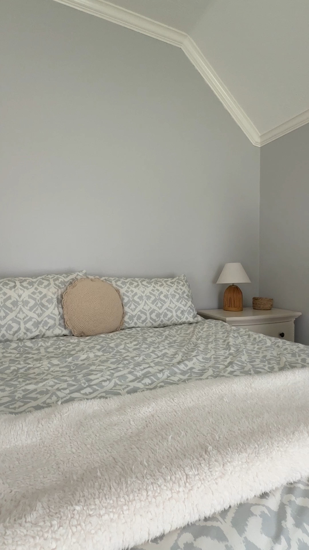 Simple Cozy Bedroom - keeping it simple with coastal bedroom vibes- light blue and white bedding, a simple round accent pillow, cozy bedside table lamp with its woven design, and finished off with a soft texture neutral throw blanket.

#LTKHome