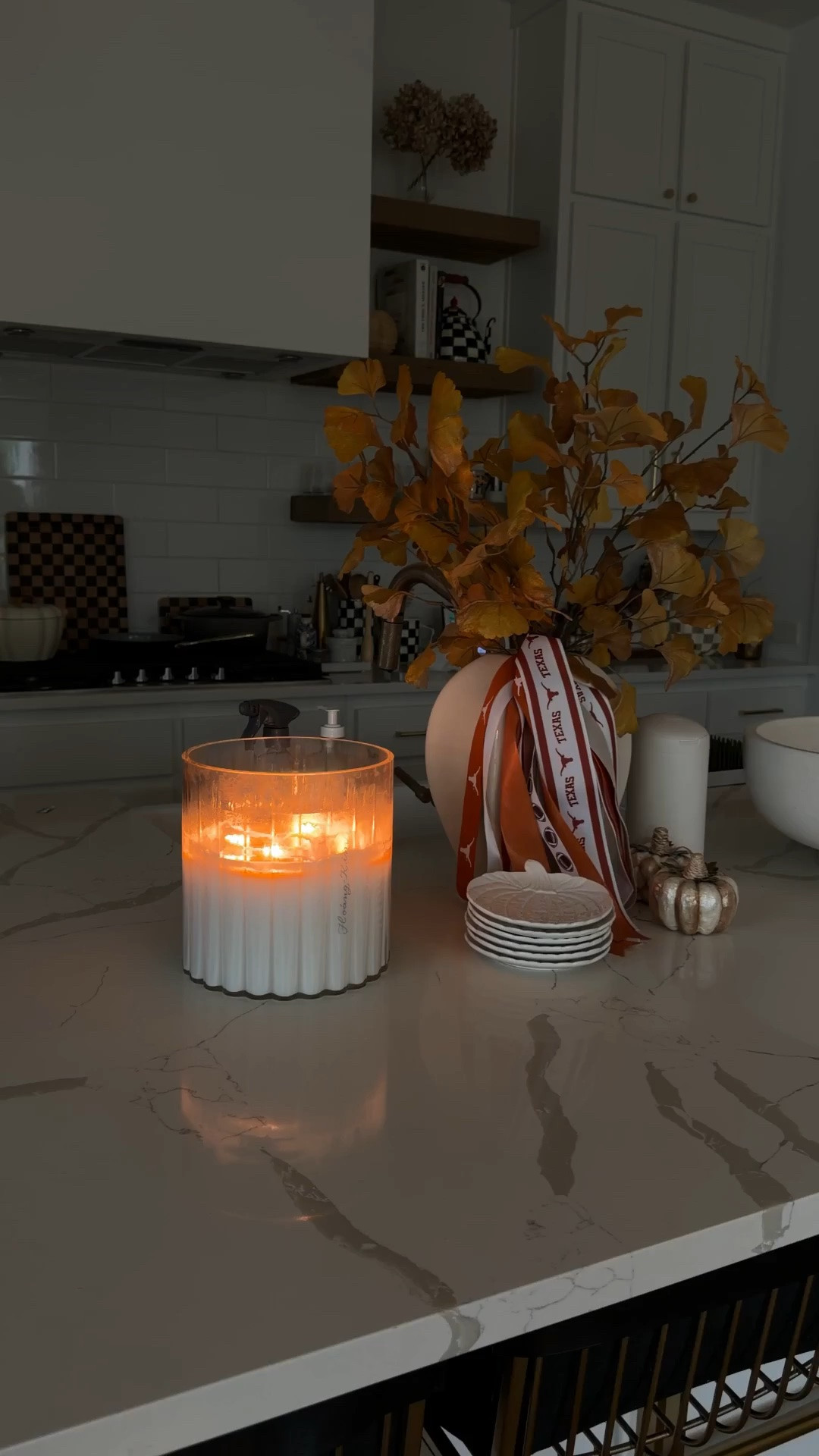 Fall kitchen decor that’s practical! A modern vase, fall stems from Target, pumpkin plates, mini MacKenzie-Childs pumpkins and, of course, baby wipes in a cute container so it lives on the island all the time!