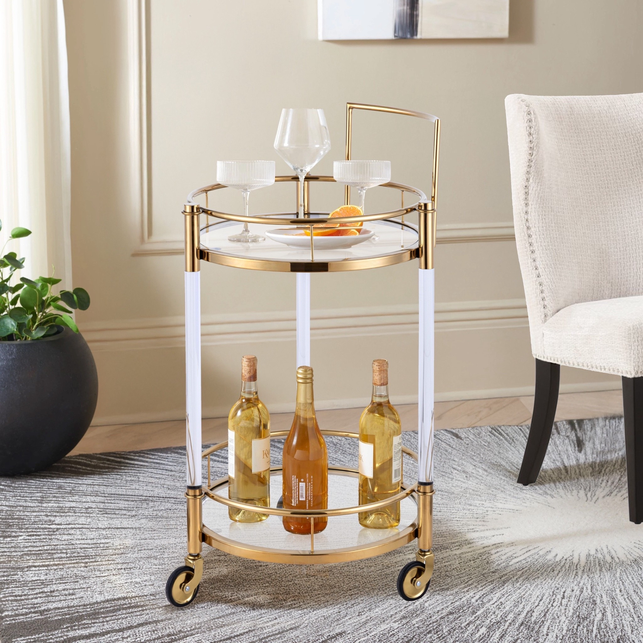 Inspired by glamorous entertaining, the Crystallin 2-Tier Bar Cart with Gold Accents & Wheels brings sophistication, style, and functionality to any gathering. Its elegant gold detailing and sleek two-tier design create the perfect setting for serving cocktails, displaying décor, or curating a chic coffee station. ON SALE and under $400.

Keywords:

* bar cart
* rolling bar cart
* gold bar cart
* 2 tier bar cart
* serving cart
* home bar furniture
* cocktail cart
* entertaining essentials
* glam home décor
* gold accent furniture
* mobile beverage station
* coffee bar cart
* luxury home accessories
* modern bar cart
* living room décor
* hosting essentials
* decorative serving cart
* chic home styling
* apartment décor inspiration

#LTKSaleAlert #LTKHome #LTKSeasonal