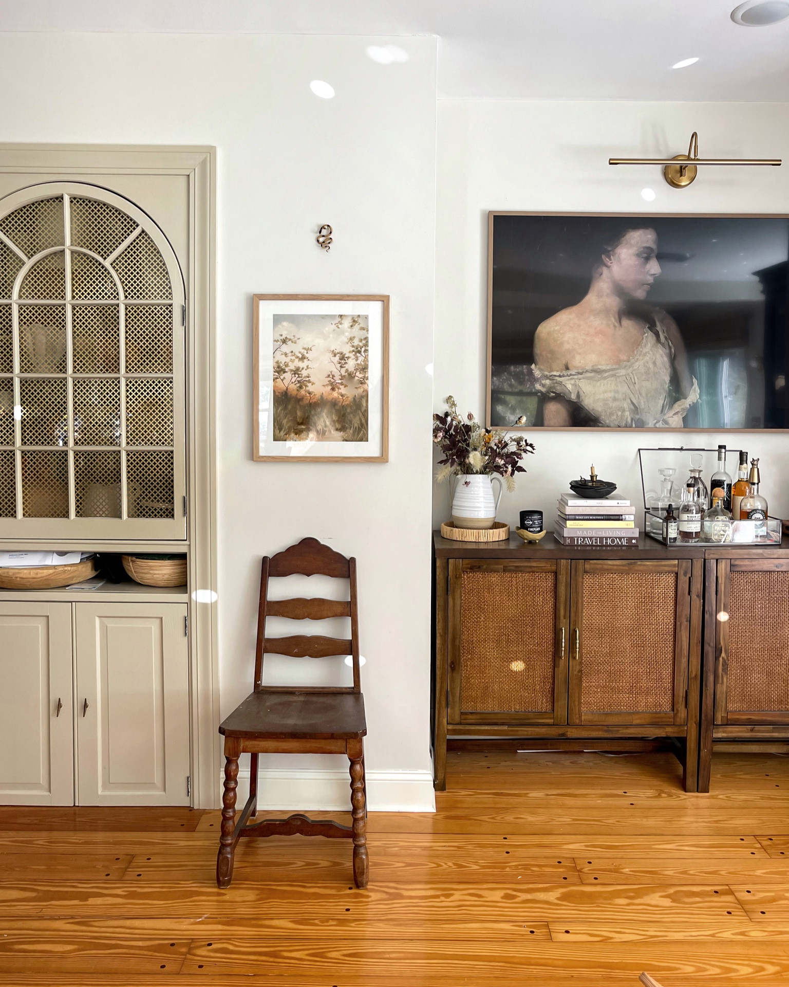 That chair was free from our town swap shop. I DIY’d the built-in decorative screen. The picture light is from Amazon. The art from @linagordievskyart. My home is collected & curated, high end & low end, vintage & new, artisan & mainstream. And I wouldn’t have it any other way…

Built in paint color is @farrowandball Stony Ground. 

#farmhousedialfano #cottagecore #vintagehomedecor #vintagehome #interiorstyling #interiorinspo #cljsquad #inmydomaine #hometohave #houseandgardenuk #bhghome #frametv #farrowandball #picturelight 

#LTKhome #LTKSeasonal #LTKunder100