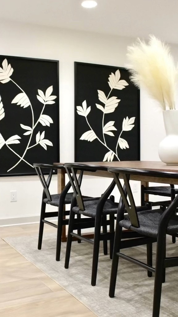 Black and white dining room moment. 🖤🤍 

Chic modern dining room decor, black and white design, large floral prints, black dining chairs, boho dining chairs, pampas grass, wood dining table, brown dining table, modern dining table, clean design, interior decorator, neutral design

#shannonrussointeriors #diningroom #interiordesigner

#LTKunder100 #LTKhome #LTKFind