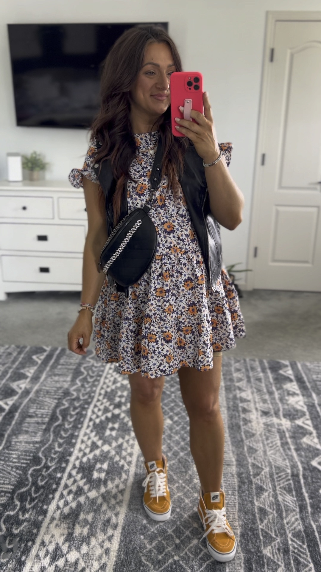 The cutest floral print babydoll dress styled on the edgy side with a faux leather vest, belt bag, and sneakers 👌 in my true pre pregnancy size and it comes in a ton of color options! I’ve arrived this one for a country concert and you can keep it girly with a cute Strappy sandal! 

#LTKStyleTip #LTKVideo #LTKBump