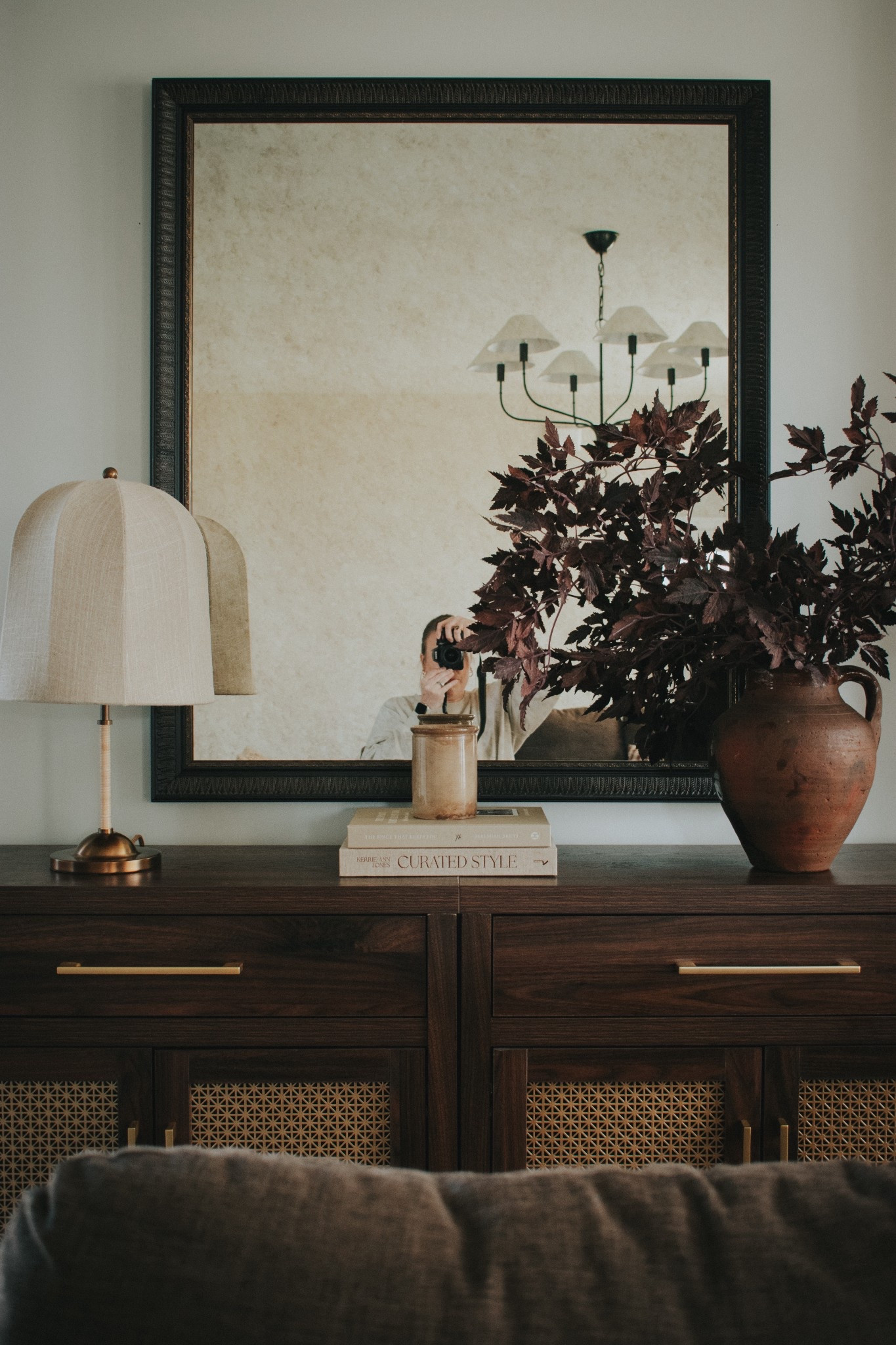 Living room console table styling. Griffin chandelier. Amber interiors chandelier. Crate and barrel lamp. Afloral stems. Coffee table books. Console table cabinet. Sideboard  

#LTKHome