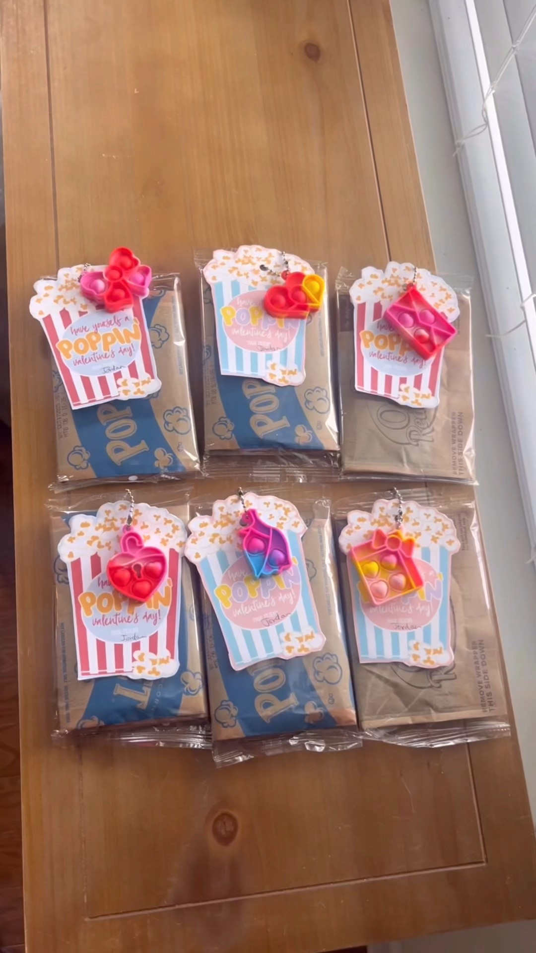 Valentine’s Classroom Exchange Idea - Popping Valentine’s with Popcorn & Pop-Its. I made these for my son before and they turned out very cute. I bought the popcorn tags from Etsy (they’re edible), downloaded them, edited out the names, printed and cut to use. 

To assemble: I punched hole in the popcorn bags (at the top corner, away from the popcorn itself), then used keychain pop-its to attach them to the bags of popcorn. They turned out super cute!🩷🩷

#LTKValentine #LTKKids #LTKmomlife