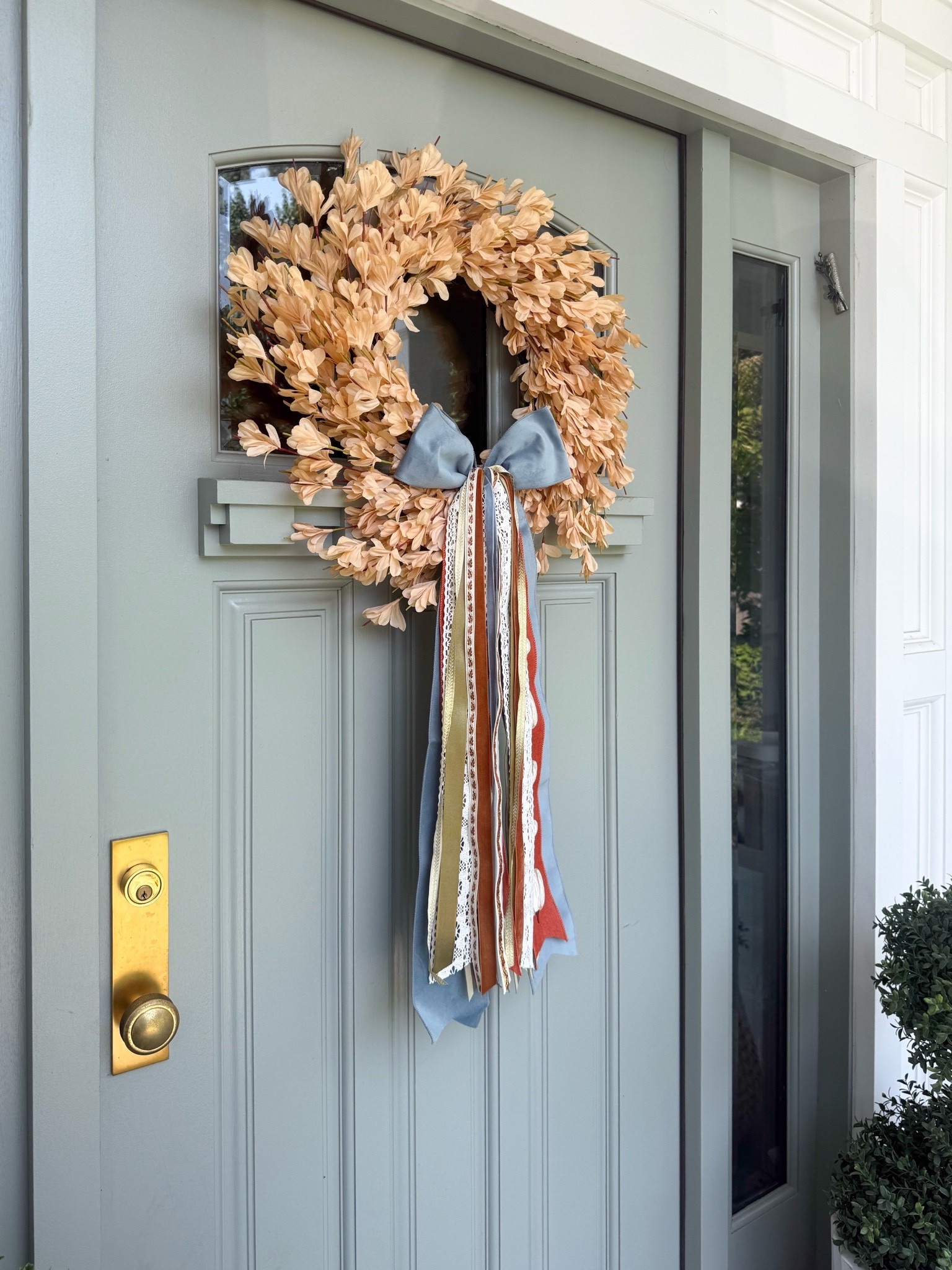 This fall wreath is such a pretty way to dress up the front door. I love the soft autumn tones paired with the blue ribbon and layered tails. It feels festive for the season while still looking fresh and elevated.

fall wreath, autumn wreath, fall front door decor, fall porch decor, seasonal door decor, decorative ribbon, front porch styling, outdoor fall decor, fall home inspiration, autumn decorating ideas, girlonthehudson