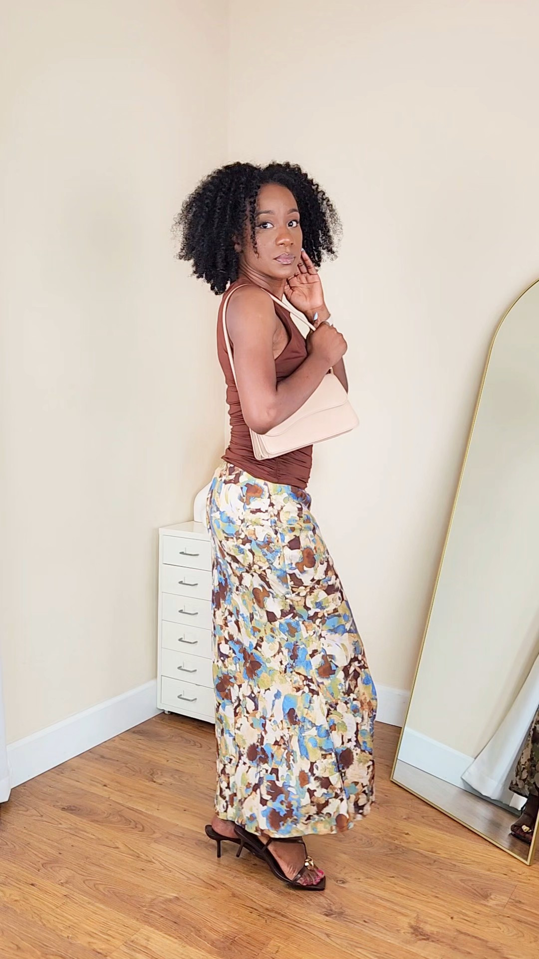 Floral midi skirt outfit styled with a fitted brown top for an easy, put-together spring look. This combo is perfect if you want something feminine but low effort, lightweight, flattering, and easy to dress up or down. Pair with neutral heels and a mini one shoulder bag for a polished everyday outfit. 

#LTKgrwm #LTKootd #LTKSeasonal