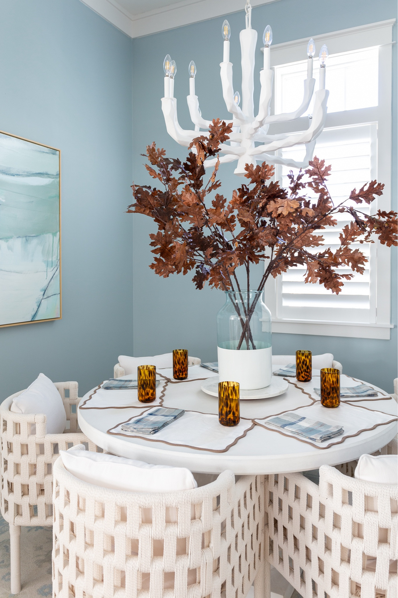 A peek at our coastal blue dining room decorated for fall! Includes my favorite faux brown oak leaves, white rope dining chairs, white concrete dining table, blue abstract art, tortoise drinking glasses, scalloped placemats, plaid napkins and marble lazy susan! #ltkhome #ltkseasonal #ltksalealert #ltkstyletip #ltkfindsunder50 #ltkfindsunder100

#LTKHome #LTKSaleAlert #LTKSeasonal