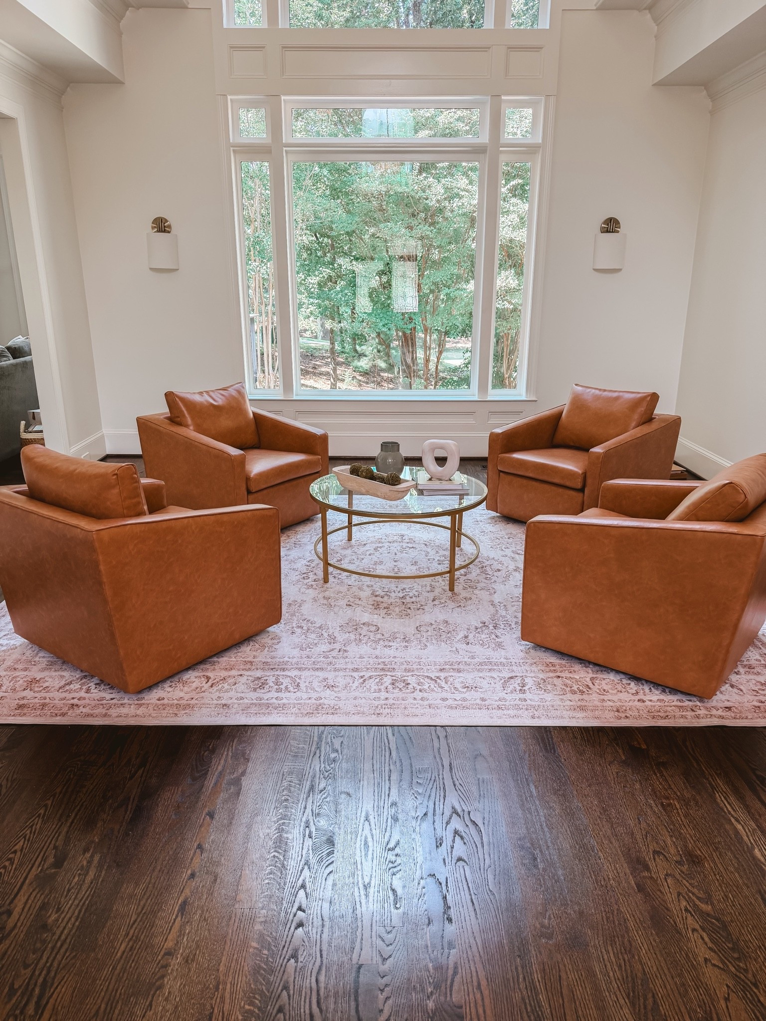 Faux leather swivel chairs
Brass coffee table
Conversation area decor
Conversation room decor
Sitting room decor

#LTKHome