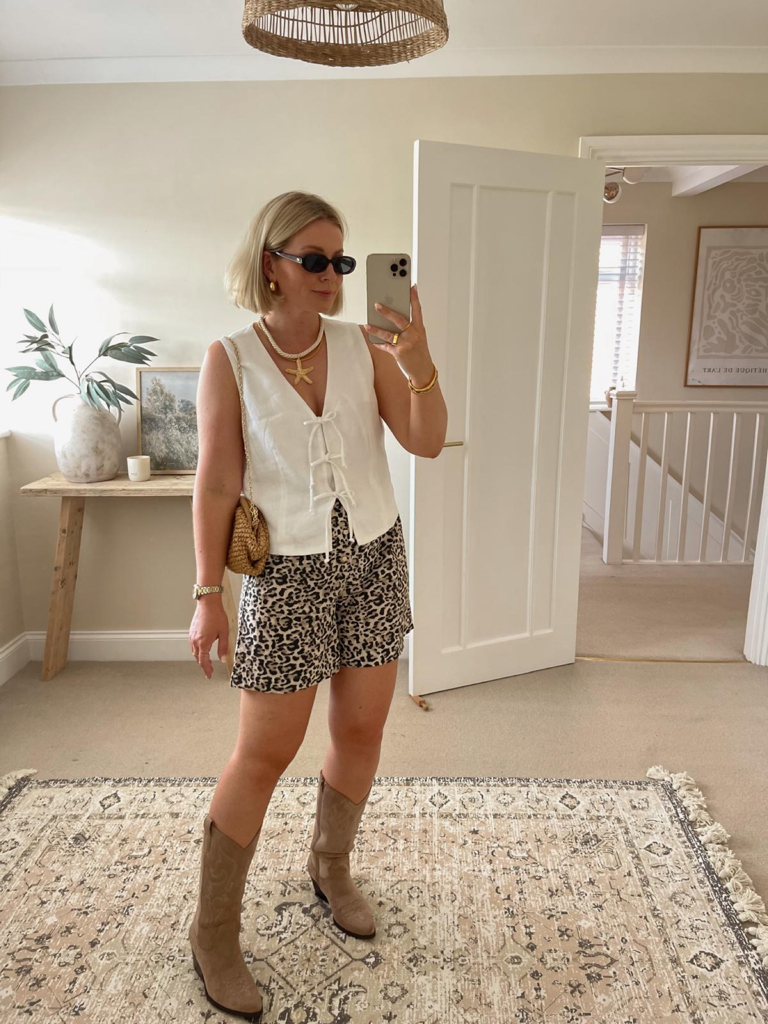 Chic summer festival & Ibiza outfit ideas - white linen tie front waistcoat from mint velvet, asos leopard print shorts, beige suede cowboy boots, mango raffia clutch bag, starfish necklace & Le Specs narrow sunglasses 

#LTKstyletip #LTKuk #LTKsummer