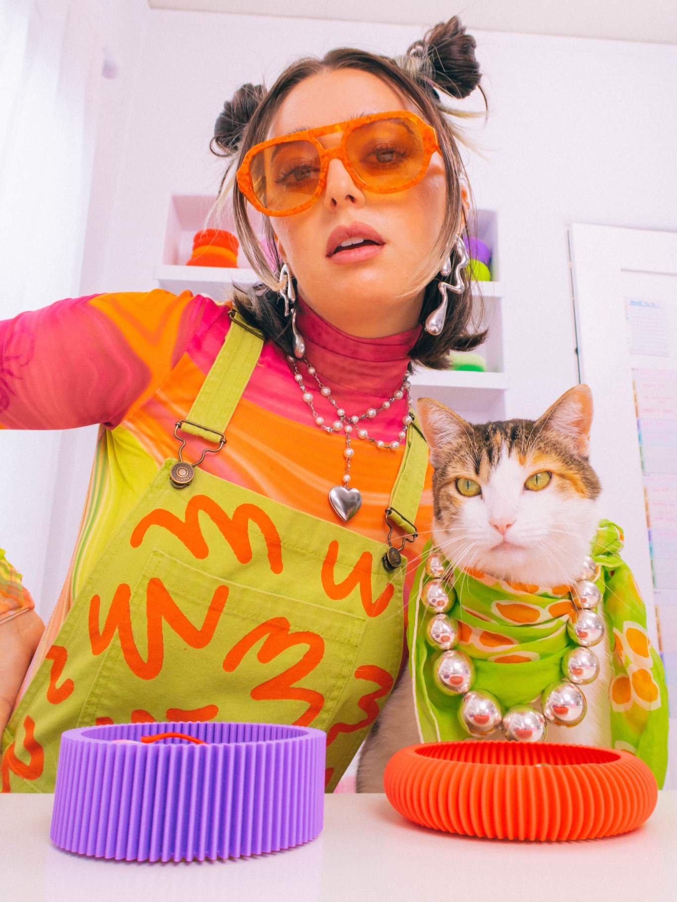 get ready with ✨meow✨🐱

Champagne wears a colorful green overall set with a pink shirt, silver, pearl heart, necklace, and silver abstract shaped earrings with orange sunglasses. Pony wears a green and orange scarf with chunky silver metallic beaded necklace.

Dopamine dressing, maximalist, maximalism, cat cat, colorful transitional fall jewelry jewels 

#LTKFallSale #LTKBeauty #LTKSeasonal