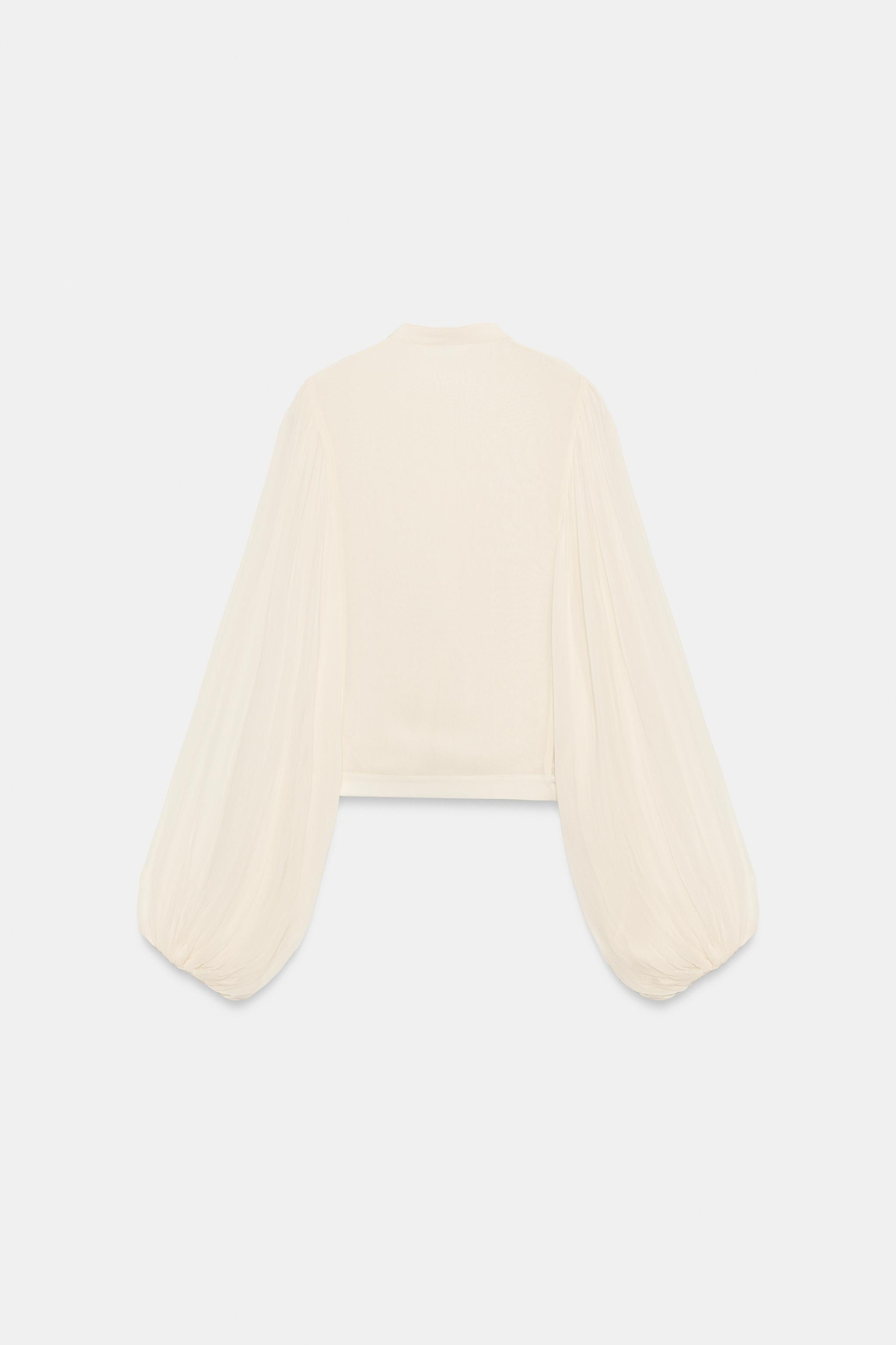 ZARA WOMAN COLLECTION. Shirt made of viscose yarn. Features a round neck and fluid long sleeves w... | Zara US