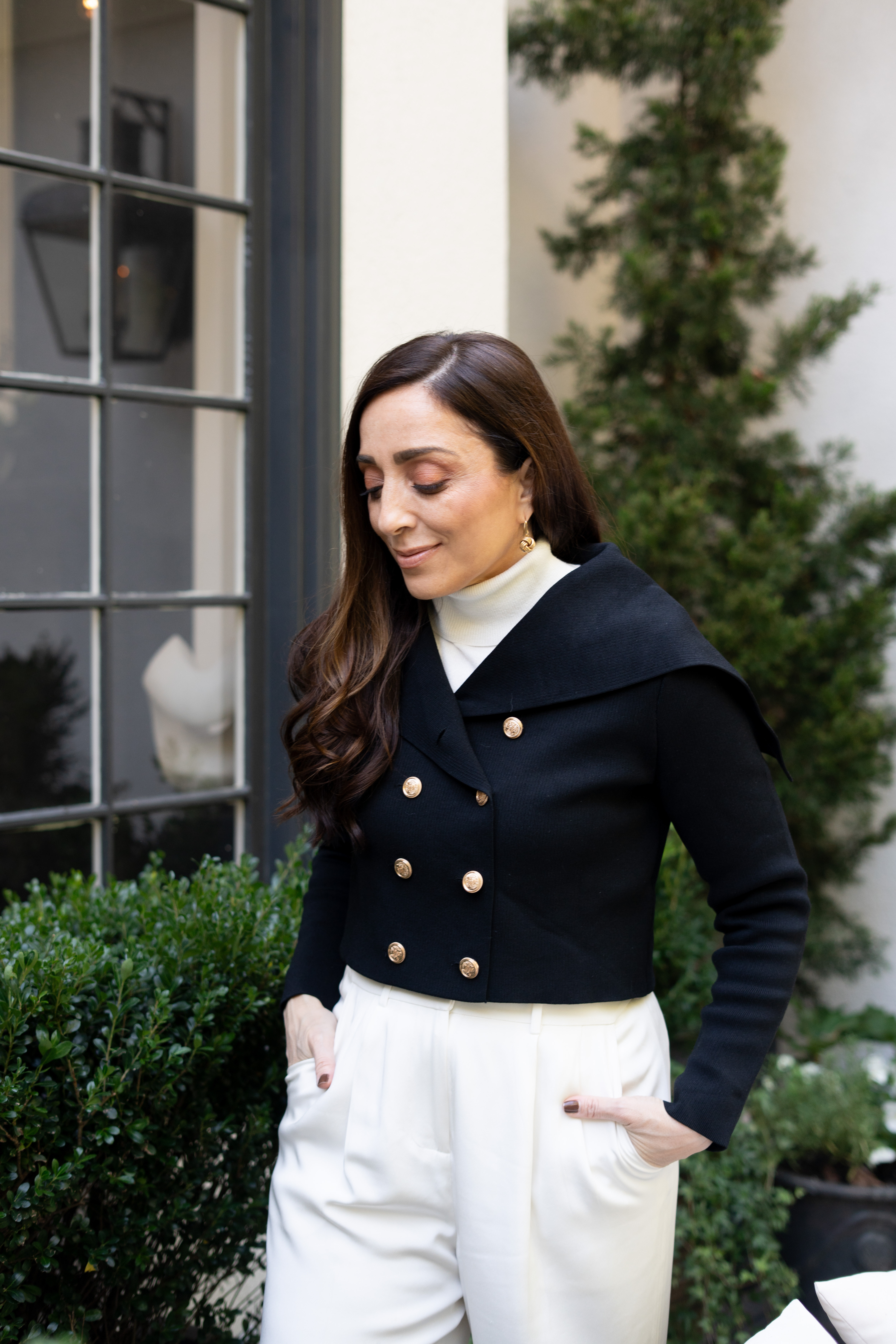 Eeeeeek I’m swooning over how effortlessly chic this whole scene feels. The crisp architecture, lush greenery, and soft neutral tones make the perfect backdrop for this classic look. My tailored white trousers and structured black jacket with gold details feel so refined yet modern. There’s something about this setting — clean, calm, and timeless — that makes the outfit pop even more. I’m obsessed with how polished and confident this moment feels!!  

 #LTKSeasonal #LTKStyleTip #LTKBeauty