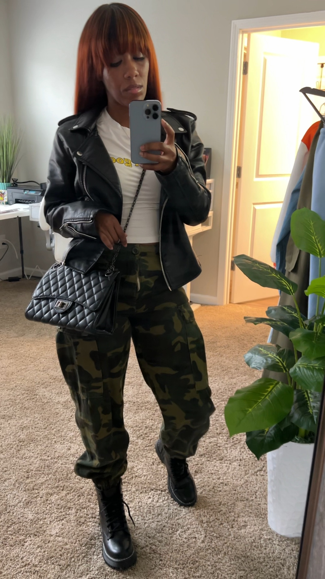 Camo cargo pants, graphic tee, black faux leather jacket, black crossbody bag, and black boots.

#LTKStyleTip #LTKShoeCrush #LTKSeasonal