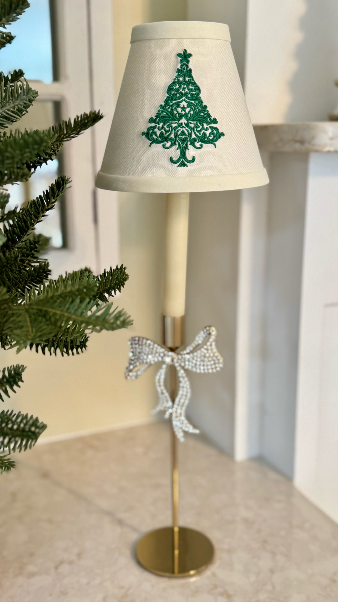 The sweetest little holiday glow ✨🎄 This mini lamp is the perfect festive accent for shelves, mantels, nightstands, or countertops. I dressed it up with a classic embroidered Christmas tree shade and a touch of sparkle with a rhinestone bow for a simple but elegant holiday look. Perfect for adding cozy charm without taking up much space.

#LTKHoliday #LTKHome #LTKSeasonal #LTKDecor #HolidayDecor #ChristmasDecor #FestiveHome #CozyDecor #MiniLamp #TableLamp #HolidayStyling #ChristmasDetails 

#LTKHoliday #LTKHome #LTKSeasonal