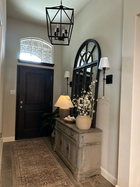 Beautiful entryway details with sconces, area rug, pottery, floral
Blossom stems, candles and decorative accents 

#LTKSeasonal #LTKStyleTip #LTKHome