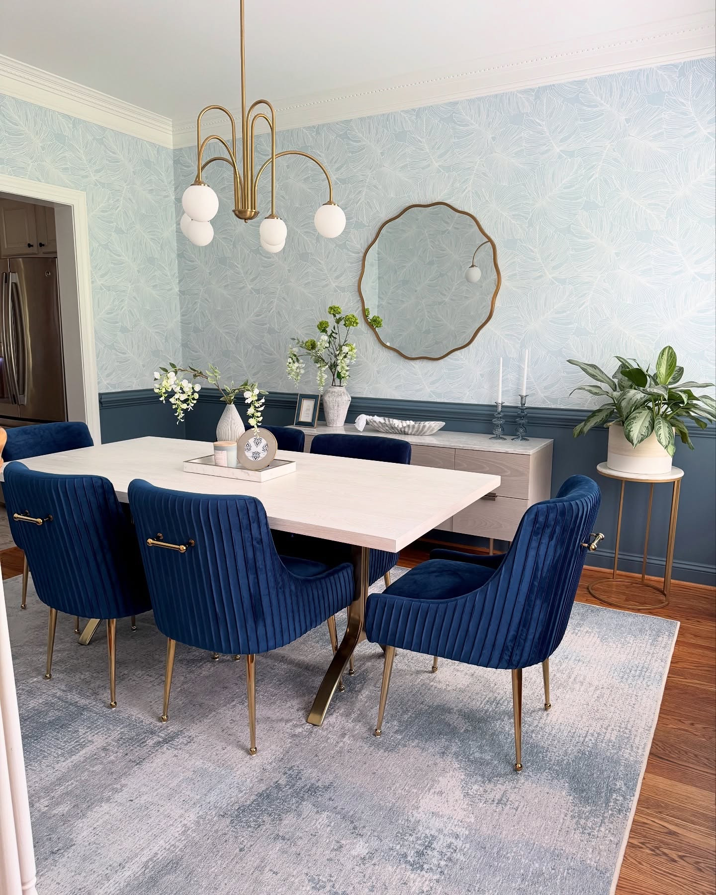 For what this dining room lacks in square footage it totally makes up for in style! My client always hated how cramped and dark the space felt! The dining table was far too wide but not quite long enough to make sense in the room so to give the illusion of more space we went with a beautiful wishbone leg table from @westelm. This piece maximizes seating while leaving enough room for the buffet. We added the most beautiful coastal inspired wallpaper and made it totally pop by painting the lower section of the room Smoky Blue by @sherwinwilliams. I love how these colors worked with the navy in the chairs and I don’t know about you, but I can’t stop staring at that beautiful, budget friendly light fixture! It’s a real show stopper!

Comment Dining for links!

#diningroom #smallspaceliving #smallspacemakeover #smalldiningroom #westelm #interiordesign #wallpaper #coastalhomedecor #coastalcasual