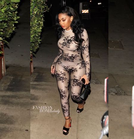 Yung Miami stepped out in a $1,200 WOLFORD
x N21 Pattie lace-paneled jumpsuit