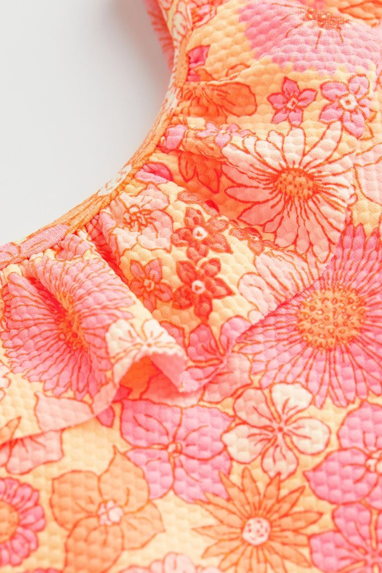 Patterned swimsuit with a textured finish. Flounce at neckline and along shoulder straps. Lined g... | H&M (US + CA)