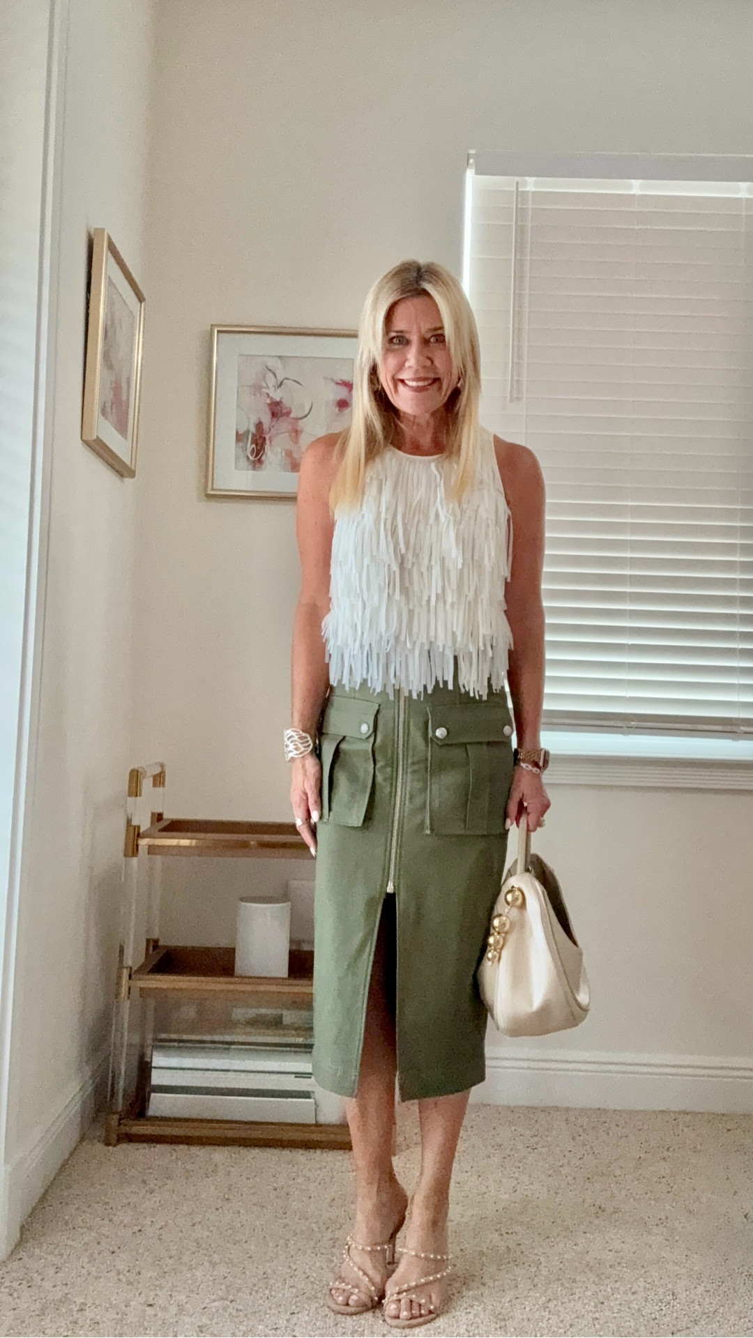 Wearing this tassel sleeveless top in winter white tucked into this olive cargo midi skirt. Fun statement outfit you can wear and it will get attention. I wore this to a networking breakfast and everyone commented on the WOW factor. Styled with neutral petal embellished sandals by Stuart Weitzman. Top is Ann Taylor (old) but tagged similar. Skirt fits true to size (wearing size 4).

#LTKItBag #LTKPetite #LTKOver40