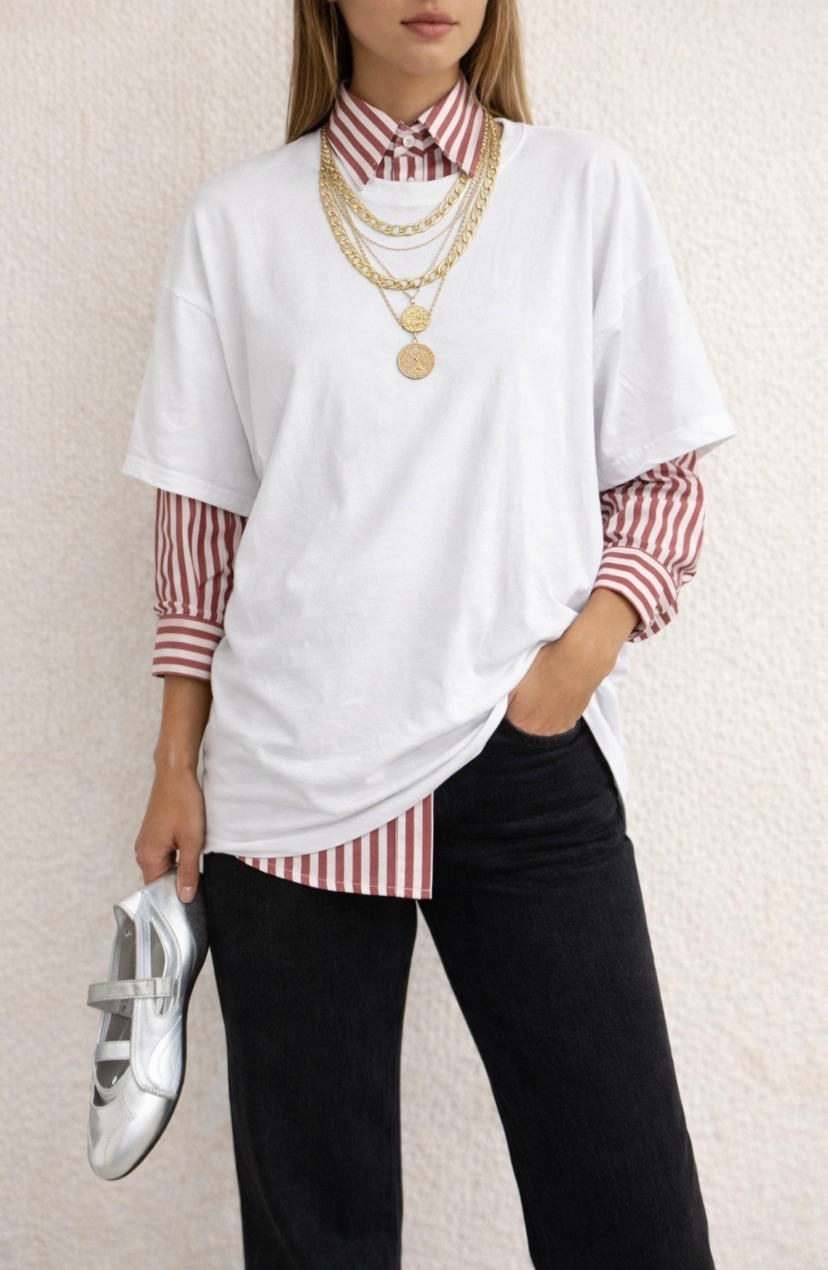 spring outfits 2026 Layered casual outfit idea featuring a red and white striped button-up shirt worn fully buttoned under an oversized white T-shirt. Paired with black straight-leg jeans, layered gold necklaces, and silver Mary Jane flats for a simple everyday look that still feels polished and comfortable.

#LTKSpringSale #LTKMidsize #LTKOver40