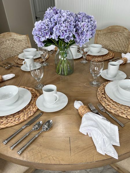 Love my pretty dining table set with white dinnerware and water hyacinth placemats and napkin rings! The purple faux hydrangeas in the center complete the look! #amazon #amazonhome #founditonamazon #homedecor #diningtable #homedecor #diningdecor #placemats #fauxflowers #flowervase #home

#LTKhome