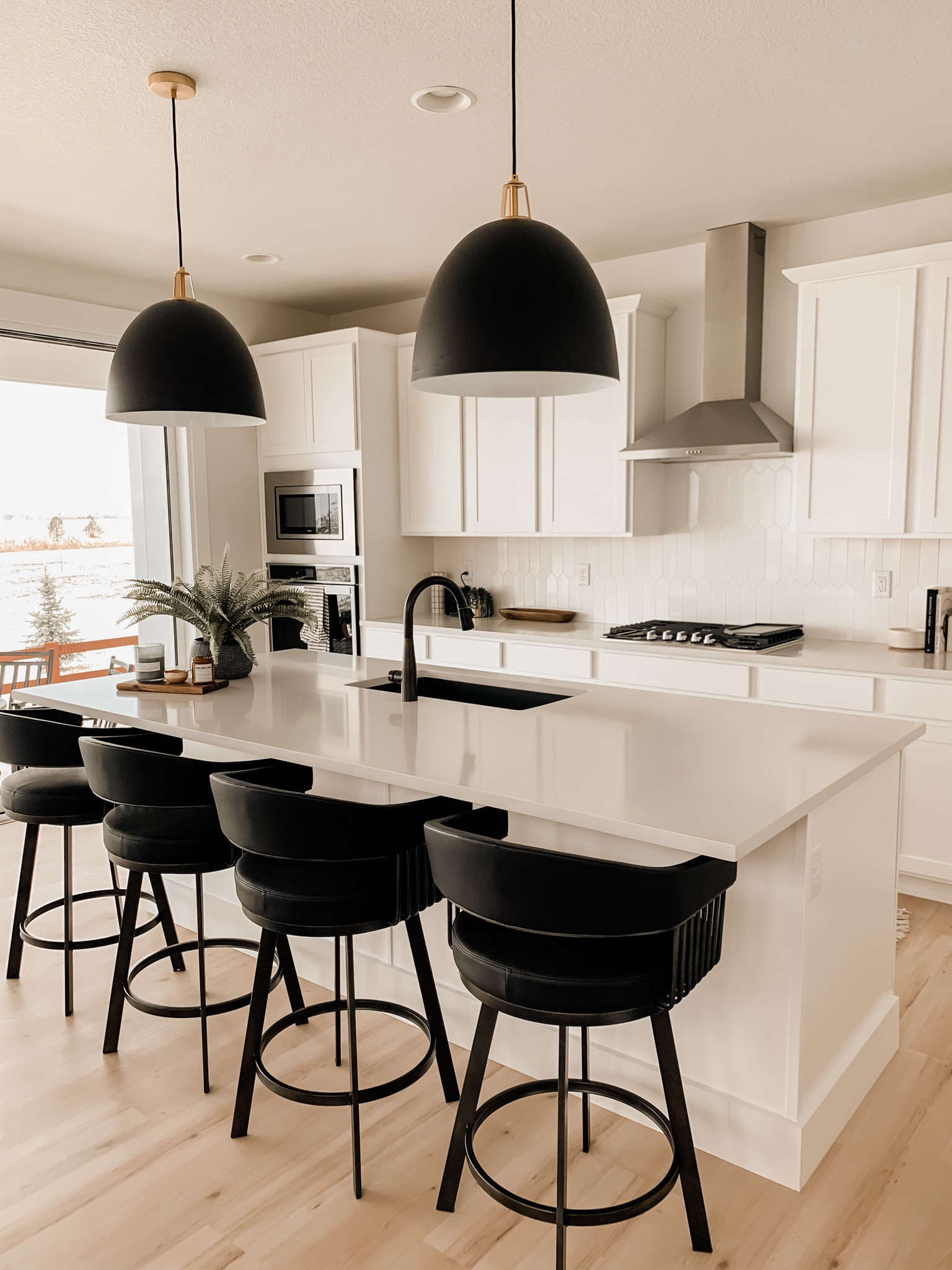 Obsessed with these black barstools in my white kitchen. The contrast is amazing! 

The pendant lights were such a fun find too. Love my kitchen!

#LTKsalealert #LTKstyletip #LTKhome