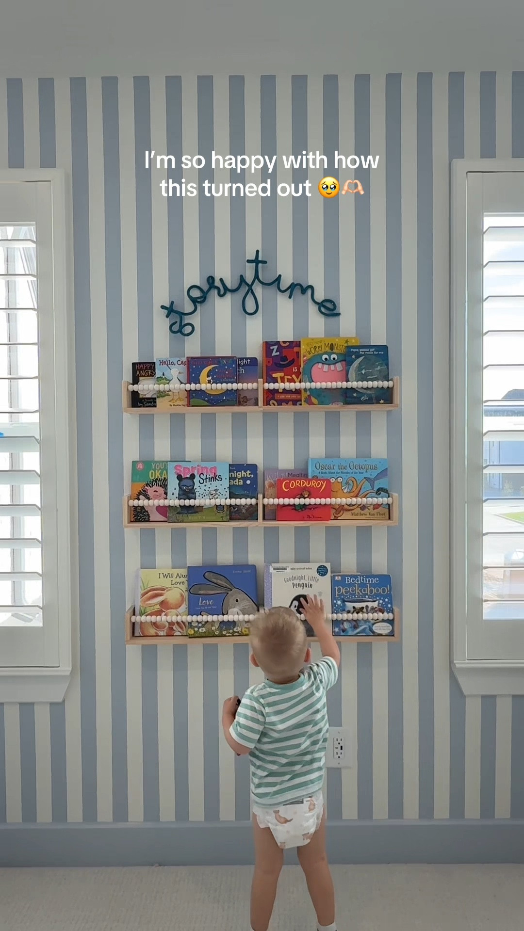 when it turns out even better than you envisioned it 🫶🏻🥹 exact bookshelves and wire sign linked. Easy install. Paint details — the shade of blue is called Upward by Sherwin Williams! It’s a very subtle pale almost grey ish blue that I feel adds the perfect touch. We hired a painter to do the stripes and then had him drench the baseboards in the same color (upward) as well as paint the doors in that color as well - makes a huge difference in the overall look! 

#LTKmomlife #LTKHome #LTKstorytime