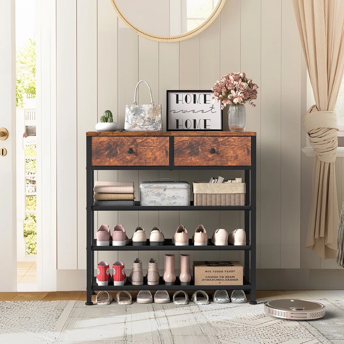 This shoe organizer from Wayfair feels more like a little entryway console than a basic shoe rack, which is exactly why I like it. The rustic wood-look top and two drawers give you a spot for keys, bags, and the random little things that collect by the door, while the three open shelves underneath hold around 9 to 12 pairs of shoes. The black frame keeps it feeling light, and it looks so cute styled with baskets, flowers, a round mirror, and a framed print on top.