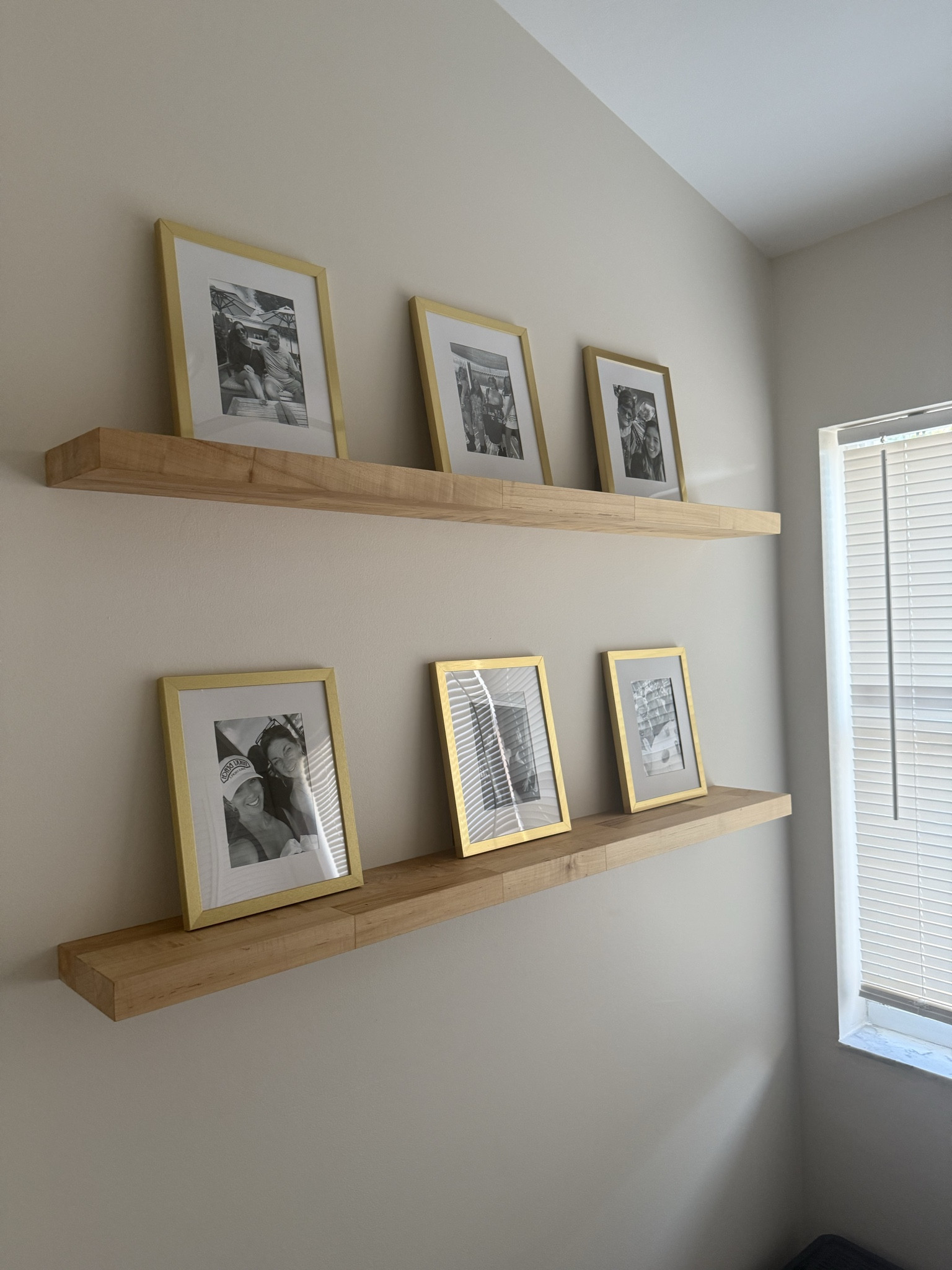Gold frames with black and white film on the wooden shelf 

#LTKHome #LTKFamily #LTKFindsUnder100