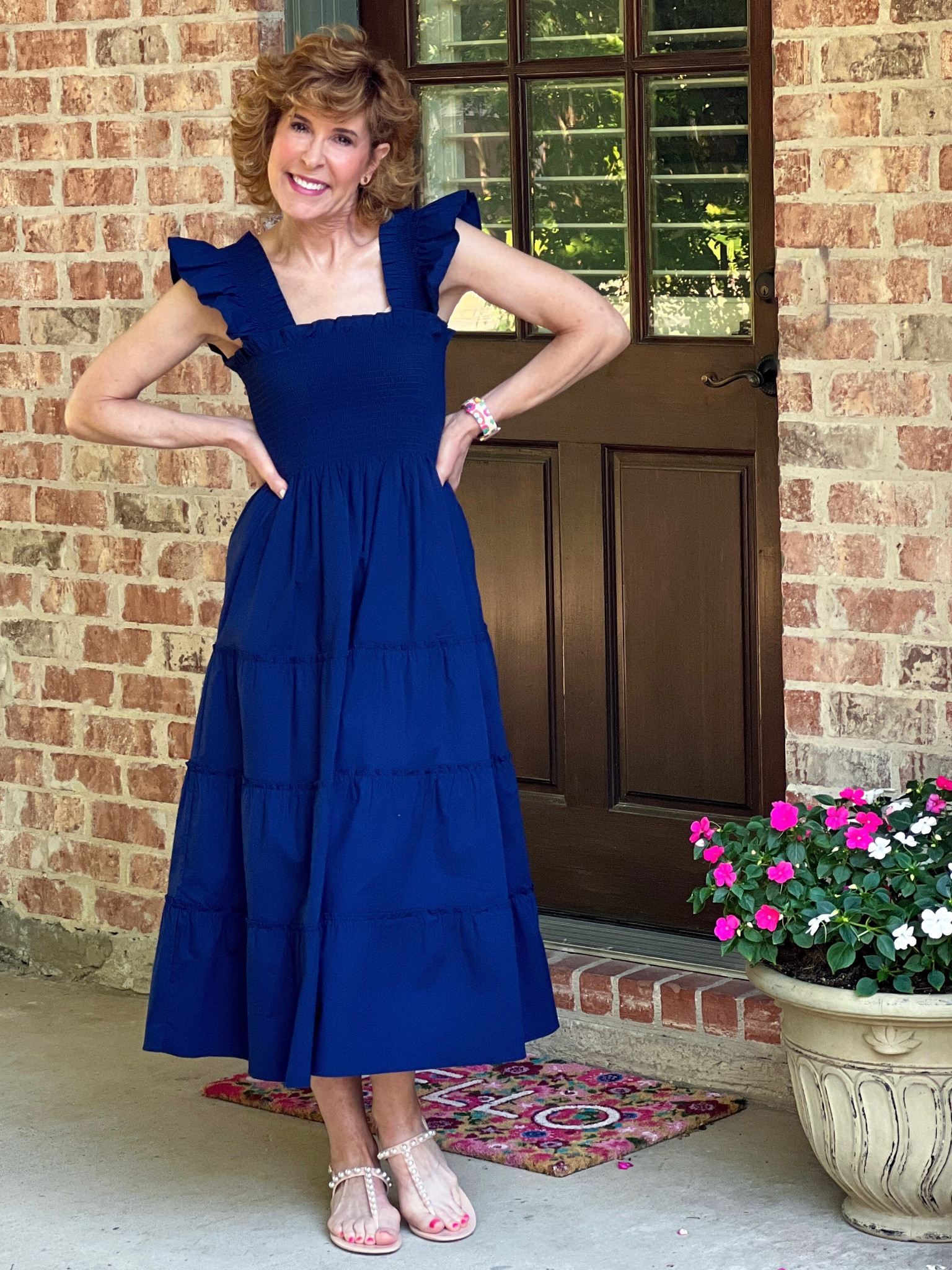 Loving this feminine nap dress in navy blue! It has a smocked top, ruffle sleeves, and a tiered skirt. It fits TTS and I’m wearing my normal XS. 

I paired it with pearl embellished jelly sandals. They’re so comfy for summer.

Designer earrings and a fun Apple Watch band finished things up!

#LTKshoecrush #LTKSeasonal #LTKstyletip