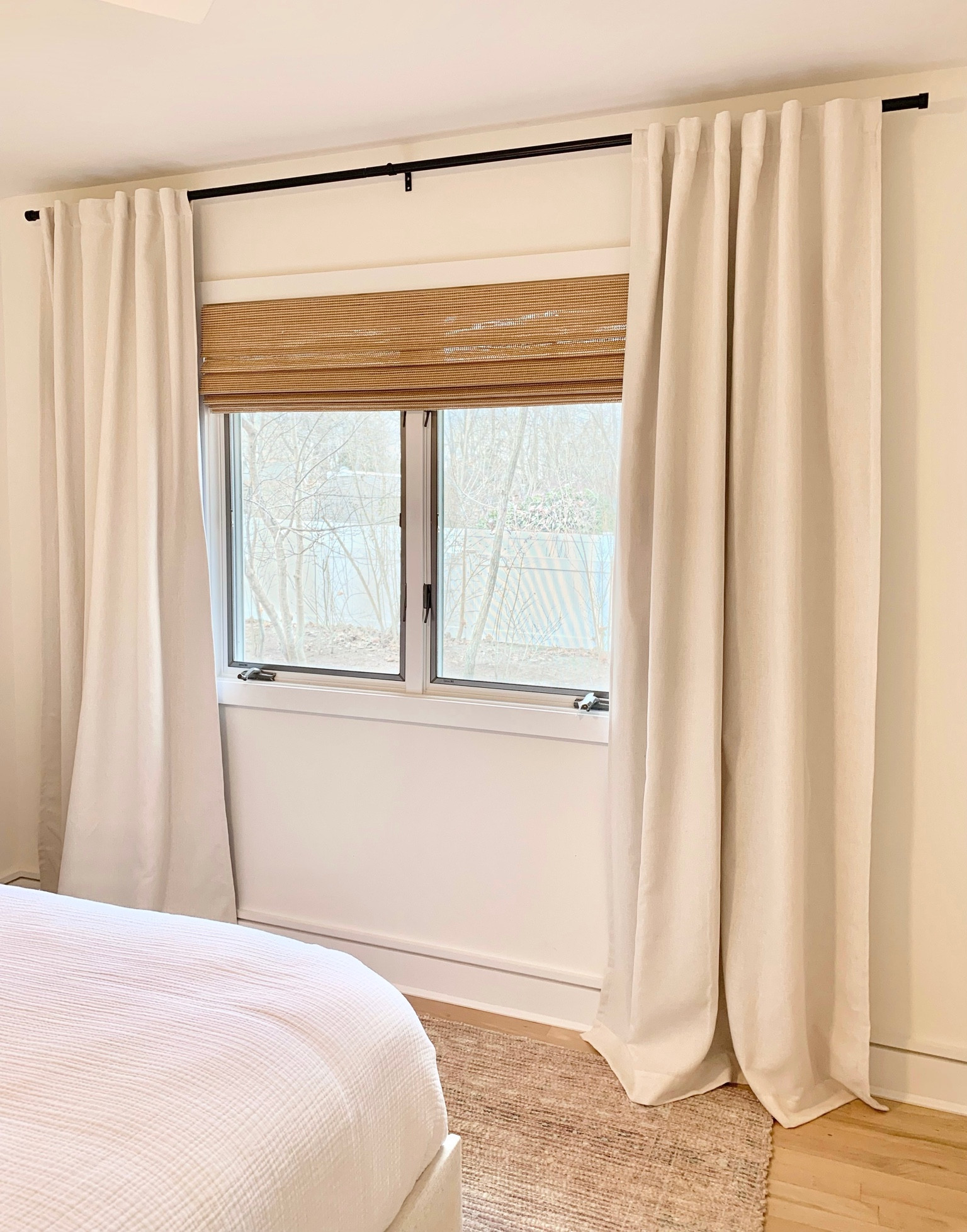 Budget friendly natural woven shades and curtains - exact ones used! Curtain color: sour cream, 95"

Bamboo blinds
Modern black curtain rod
Neutral rug
Cream
Neutrals
White bedding
Bedroom
Living room
Home decor

#LTKunder50 #LTKunder100 #LTKhome