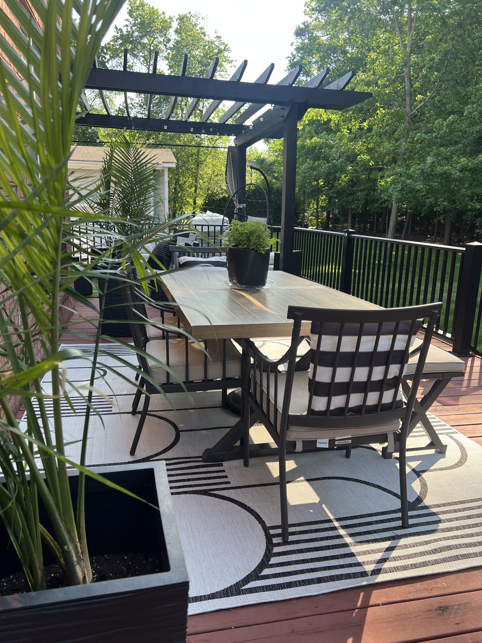 Outdoor dining set up in black, white and lots of greenery! Dining set and rug are both on sale. Similar planters linked  #LTKhome #LTKsalealert

#LTKSeasonal