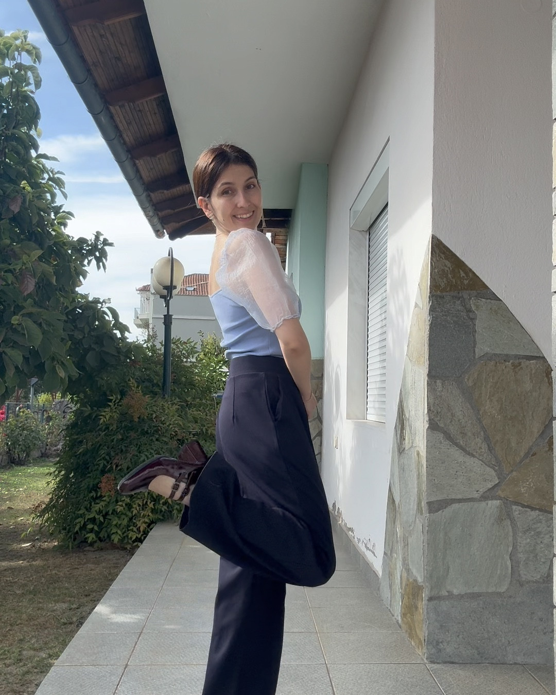 There are many traditions in a Greek Orthodox wedding. One of them is call “Make the bed”. Basically the single friends of the bride are making the bridal bed in which the couple will sleep on the first night after the wedding. This is the outfit I wore on that day as the koumbara (maid of honour). The colours of the wedding were blue and green and I’ve decided to keep a blue theme on all the outfits I wore regarding the wedding. 

I wore a light blue top with a navy blue pair of wide pants. A pair of burgundy pumps and a pink bag completed the look. I went for gold accessories. My favourite long Chanel earrings, a gold minimal necklace, a gold bracelet with rhinestones and a Swarovski gold ring. Swipe to see me on the actual day. Unfortunately I didn’t have a full outfit shot from the day so I had to re-shoot it again. I forgot the watch though, oops 🙈

#LTKeurope #LTKpartywear #LTKwedding