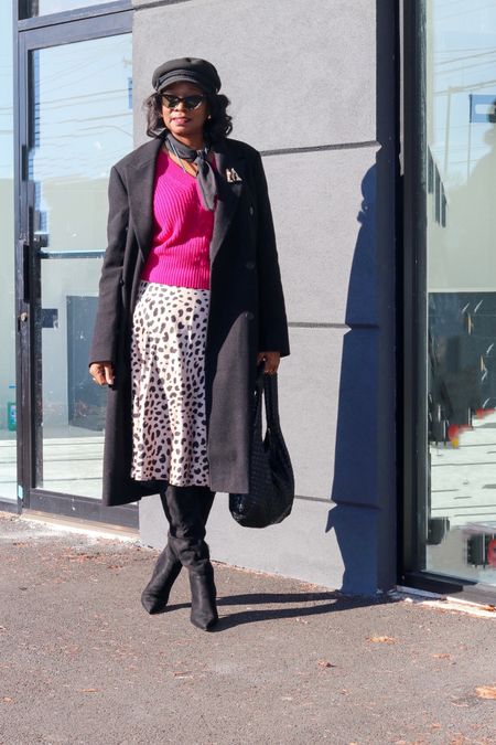 Leopard print skirt w/a sweater to brighten up the winter day; black tall boots and dad double breasted coat 