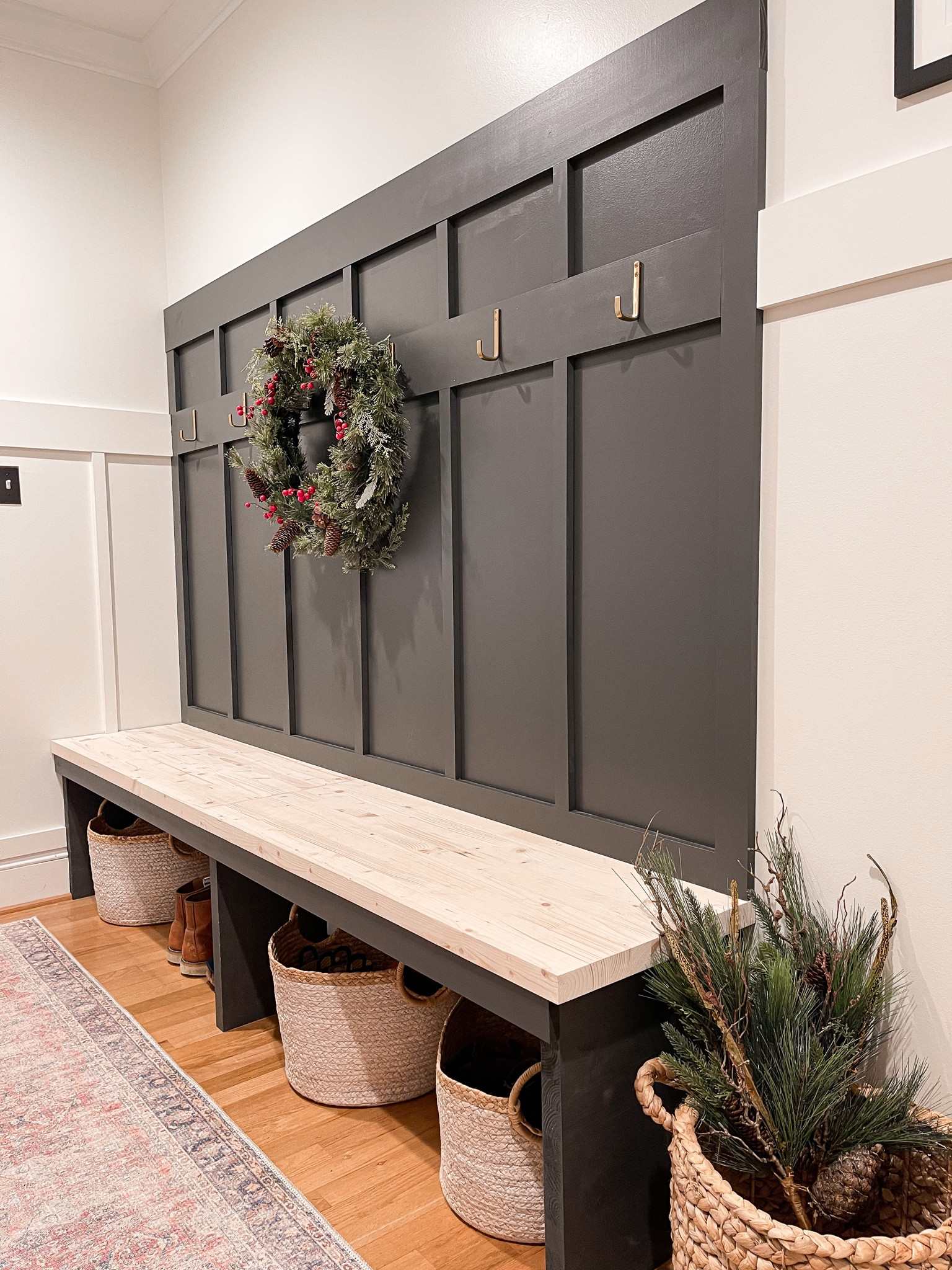 Simple mudroom  holiday decor. Wreath and greenery in basket 

#LTKHoliday #LTKhome #LTKSeasonal