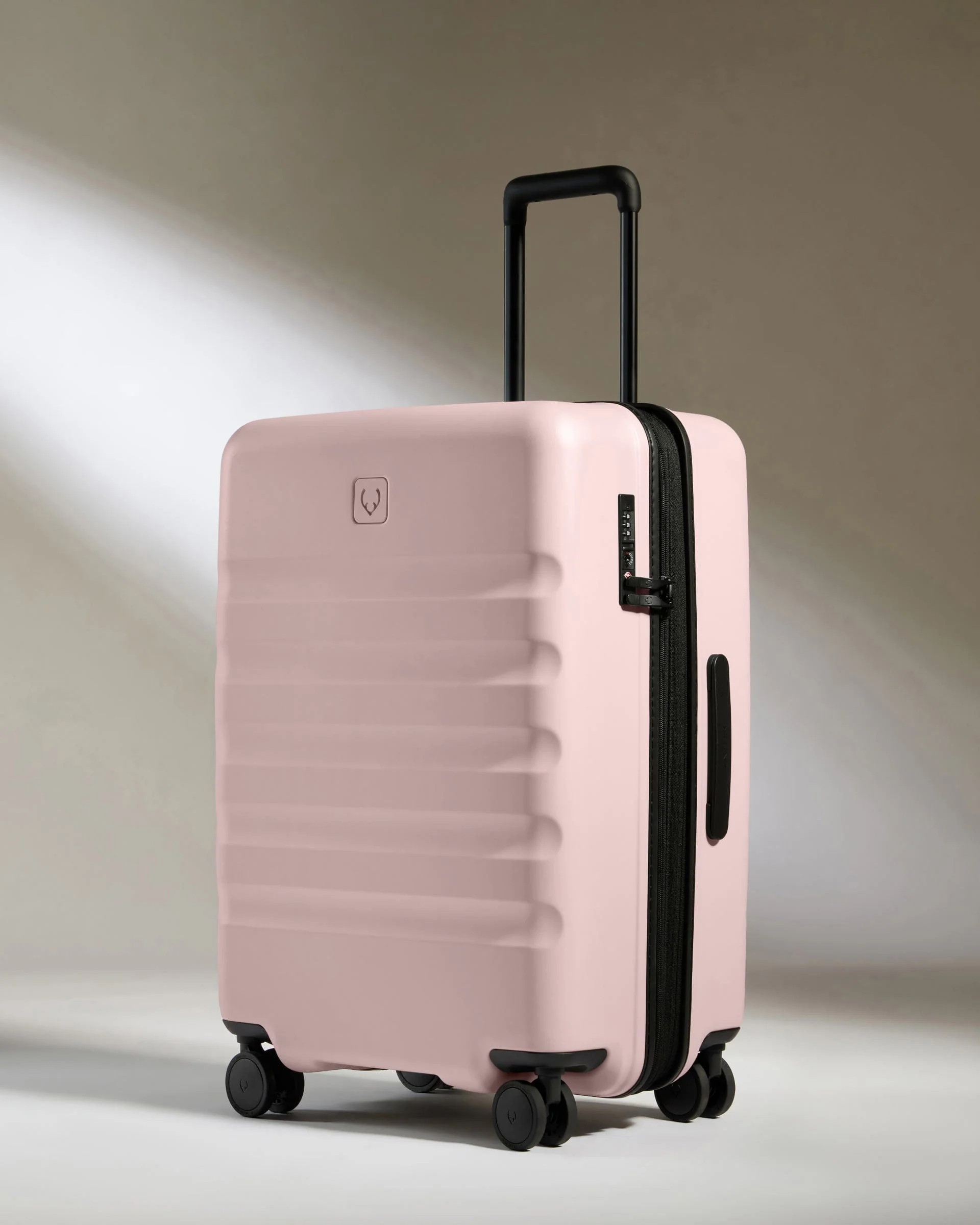 Medium suitcase in Moorland Pink - Icon Stripe | Lightweight & Hard Shell Suitcase | Antler UK