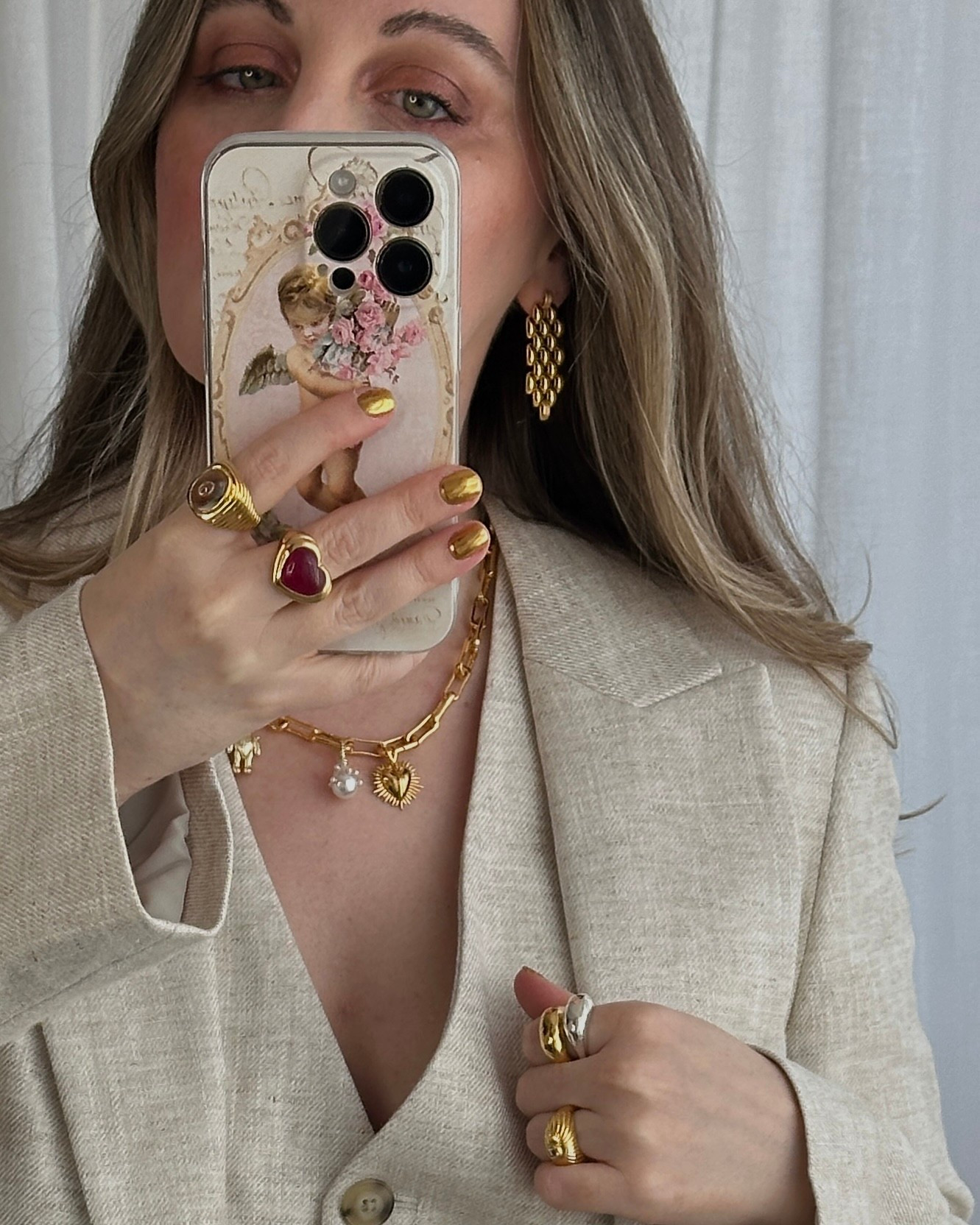 My weekend glow ✨ Mixing silver and gold because why choose? Added a heart cocktail ring for the drama and chain details for that winter sparkle - all with a linen suit that keeps it effortlessly cool.
.
mirror selfie, mixed metals, silver and gold jewellery, dome ring, cocktail ring, charm necklace, chain earrings, festive accessories, party season jewellery, holiday outfit ideas, Black Friday jewellery, gift guide, statement rings, everyday glamour, linen suit 

#LTKluxury #LTKwinter #LTKgiftguide