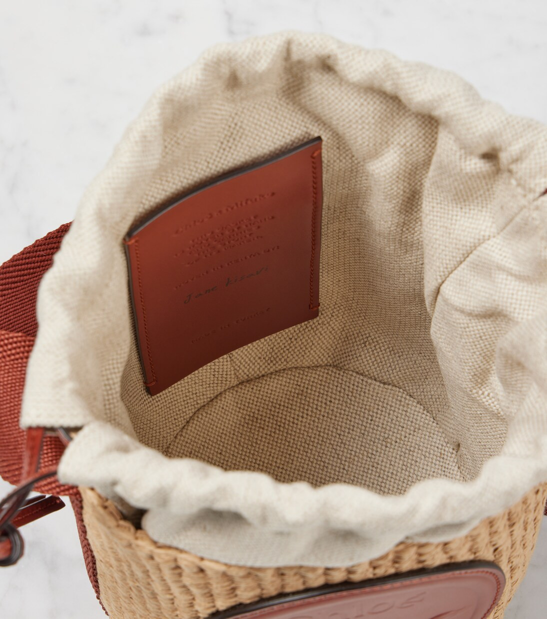 Horse Medal Small woven bucket bag | Mytheresa (US/CA)