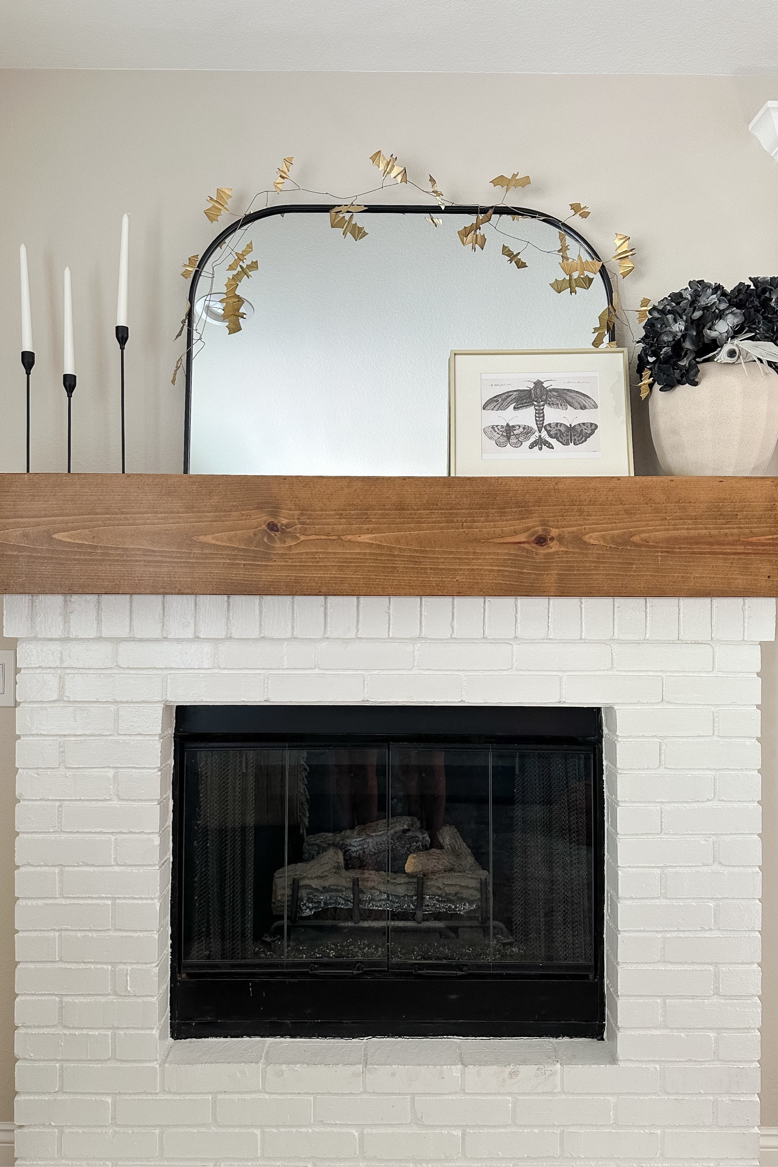 Halloween mantel 

Halloween fireplace. Moth art. Butterfly art. Black candlestick holders. Black arch mirror. Brass bat garland.

#LTKSeasonal #LTKHome #LTKSaleAlert