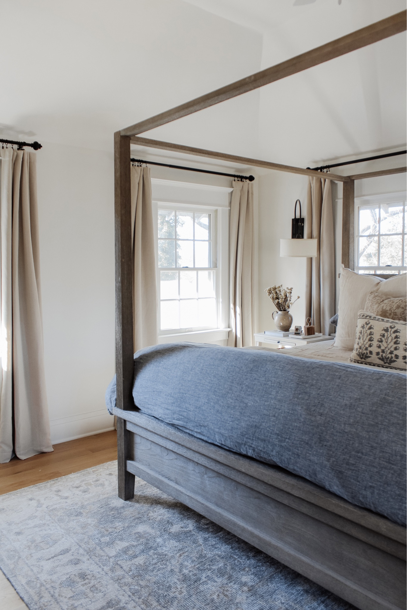 Rug Review | As I begin to style the second floor spaces, it was important to me to find a rug I truly loved given how much it anchors the room. On the blog, I’m sharing my review of this hand-knotted rug to serve as a quality vintage look for less ✨ link in bio to read + shop! 
•
•
•
4 poster wood bed, natural tone wood bed, canopy bed, linen duvet, stripe euro shams, floral decorative pillow, bed pillows, pillow inserts, cotton gauze quilts, layered bedding, nightstand decor, white two shelf nightstand, affordable furniture, quick ship furniture, swing light, nightstand wall light, affordable curtain, neutral bedroom, bedroom decor, black curtain rod, vintage decor, Target home, woven basket, lumbar pillow, floral throw pillow cover, blue bedding  Vintage look, patterned rug, muted rug, bedroom rug, light blue rug, neutral rug 