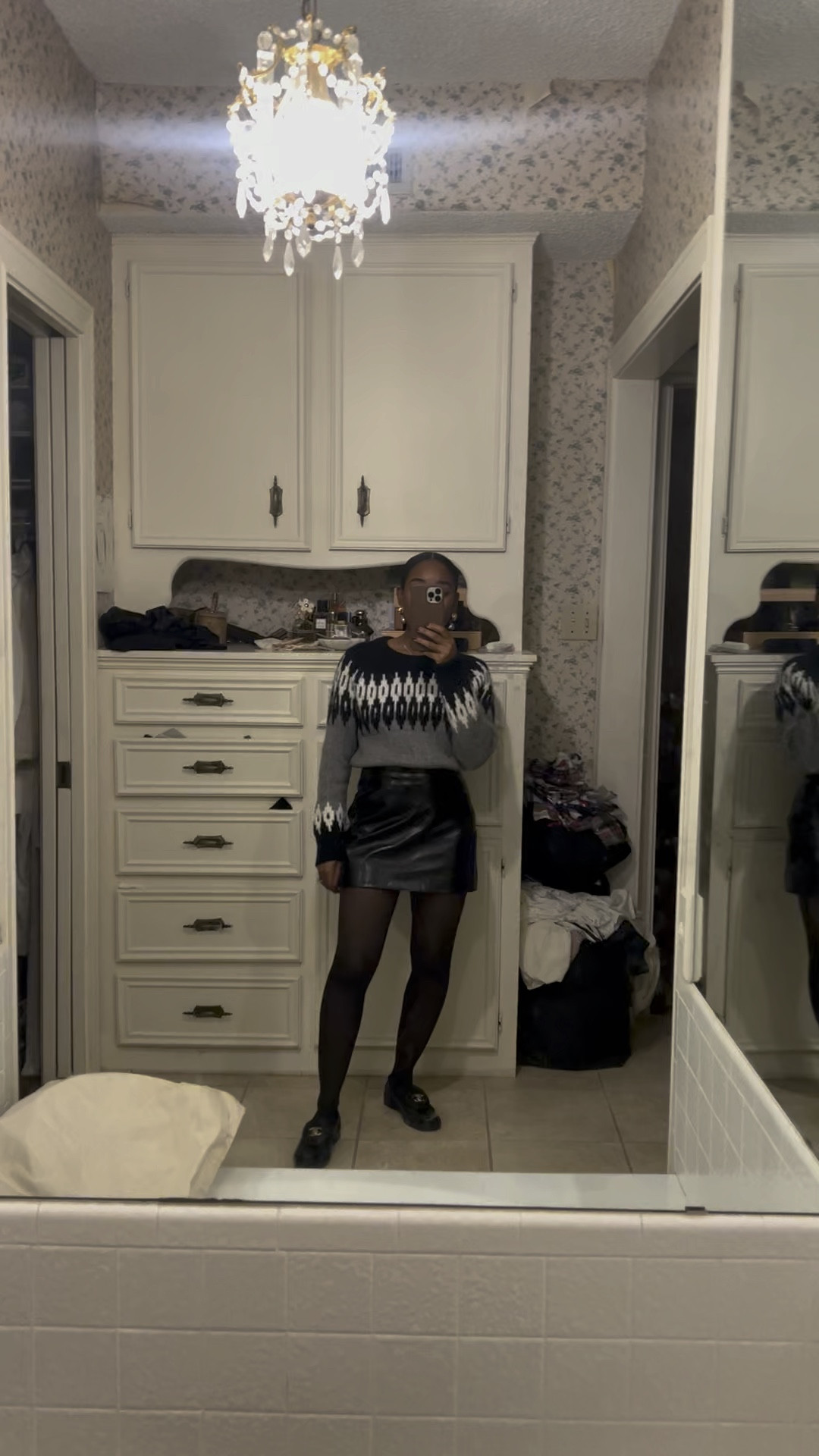 Christmas outfit: Fair aisle sweater, black faux leather mini skirt, black loafers, hair styling cream red lipstick, earrings 

#LTKstyletip #LTKHoliday #LTKbeauty