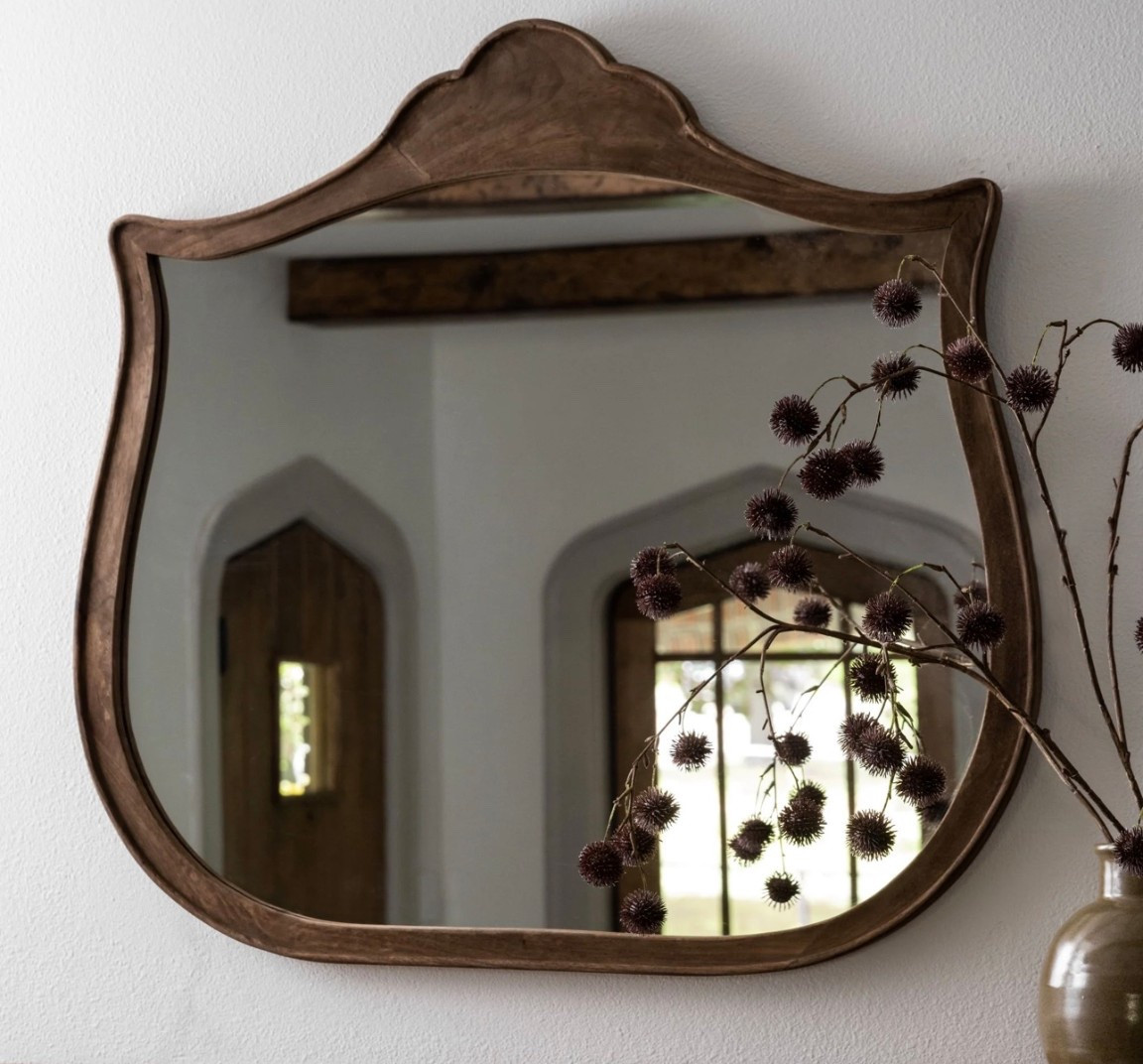 Wood carved details on this mirror adds character to any space, displayed on a mantel or hung on the wall. 
#LTKfinds
#magnoliahomefinds
#archedmirror
#interiordecor

#LTKHome