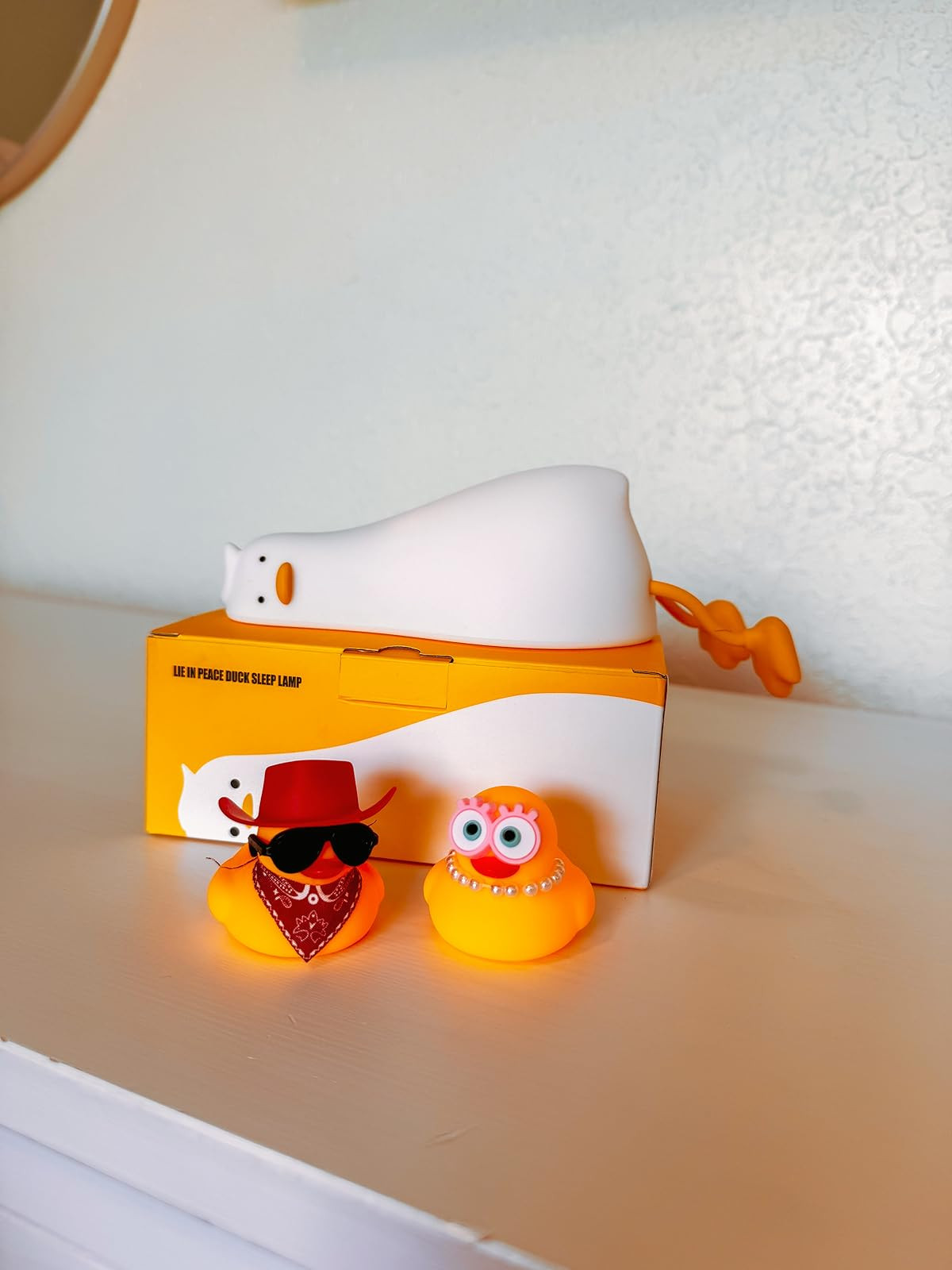 Cutest bedtime crew ever? We think yes. This “Lie in Peace” duck sleep lamp is the perfect addition to any nursery or kids’ room—soft, soothing light and totally adorable vibes. Paired with these dressed-up rubber duckies, this shelf setup adds charm, personality, and a little humor to your little one’s bedtime routine.

duck night light | cute nursery decor | toddler sleep essentials | kids night lamp | playful nursery ideas | rubber duck toys | fun kids room accessories | baby room shelf styling 

 #LTKHome #LTKBaby #LTKKids