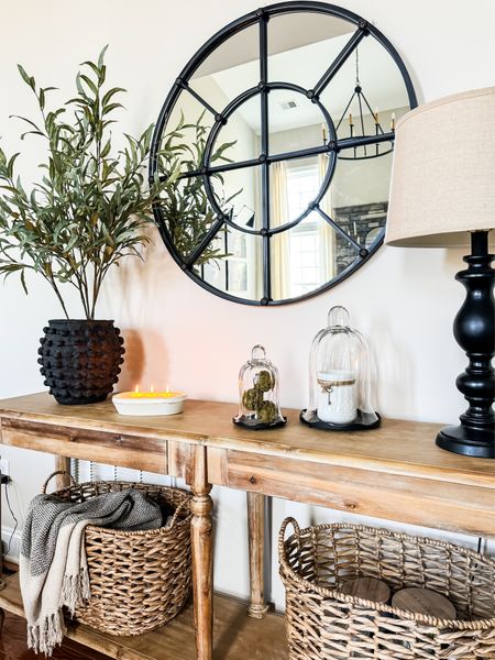 Spring console table styling ideas. Beautiful set of fluted glass cloches filled with jar candle and moss orbs. Popular minka vase with faux greenery. Round mirror wall decor hung over natural wood table  

#LTKstyletip #LTKhome #LTKSeasonal