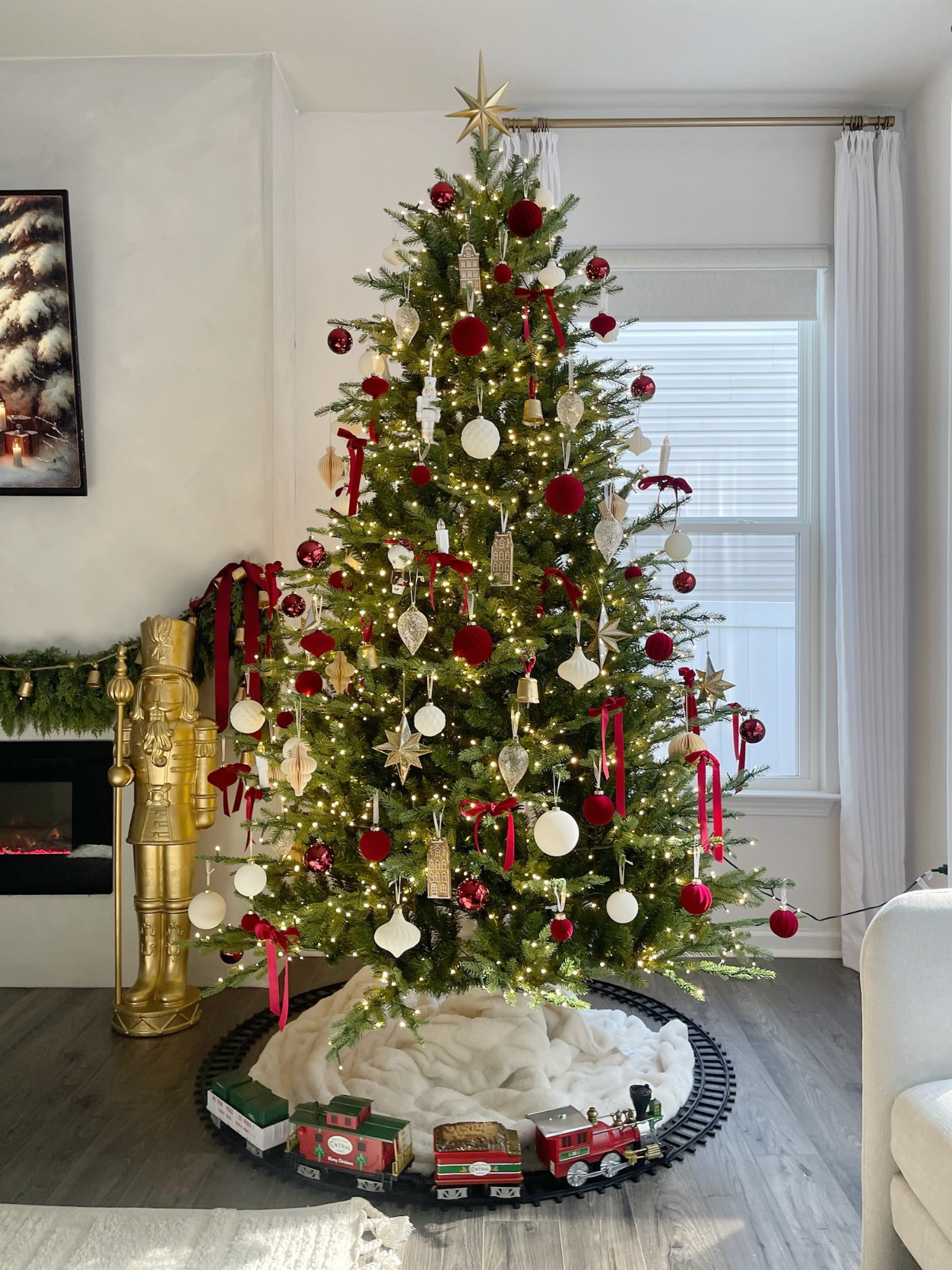 Nostalgic Christmas tree decor. Christmas tree 2025 using intense red and burgundy with traditional Christmas ornaments and a beautiful North Pole train 

#LTKHome #LTKSeasonal #LTKHoliday