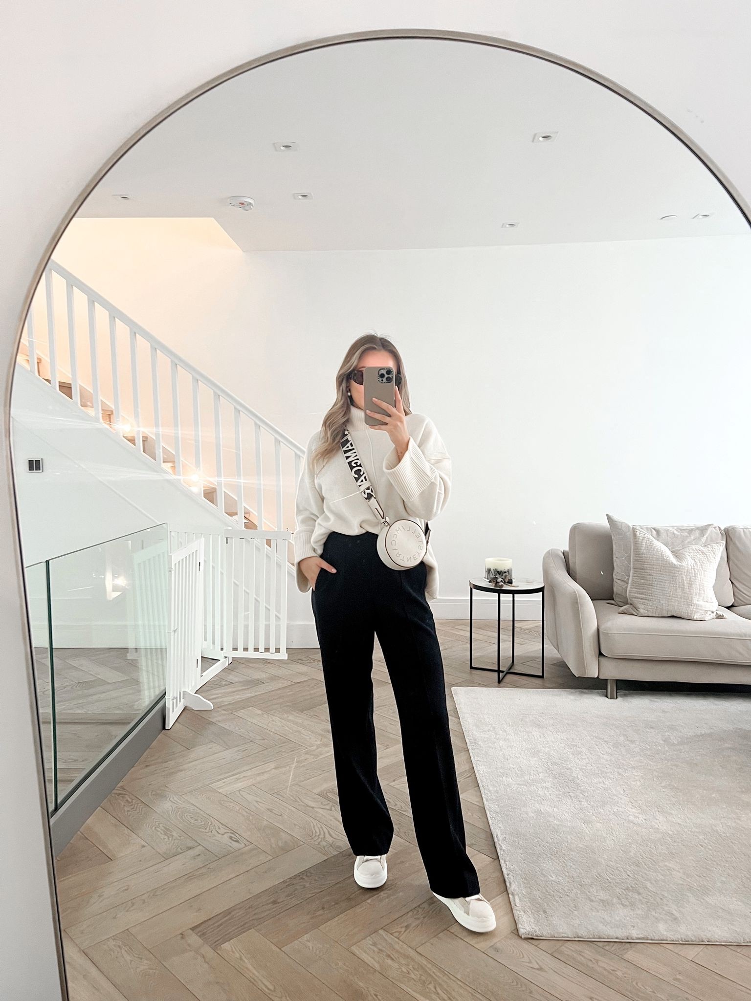Neutral toned cosy outfit - wide leg tailored trousers & white jumper from Reiss, Chloe Lauren trainers, prada tortoiseshell sunnies, Stella McCartney round bag & belted camel coat  

#LTKstyletip #LTKSeasonal #LTKshoecrush