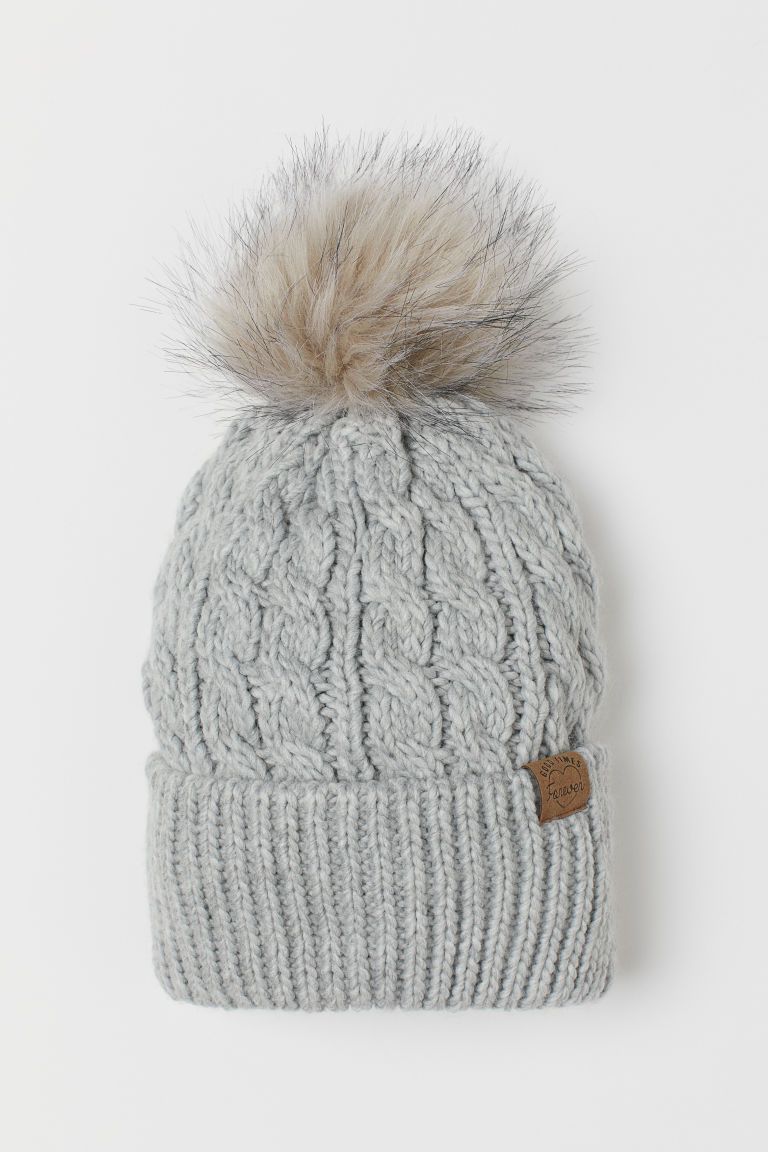 Soft, cable-knit hat with a faux fur pompom at top and a ribbed cuff. Cotton jersey lining. | H&M (US)